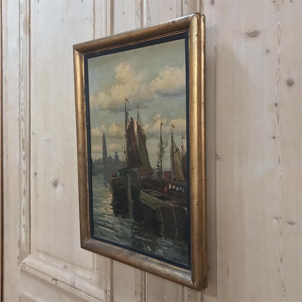 Antique framed oil painting on board by Reynaert depicts an impressionistic harbor scene at dawn with the fishing fleet just departing for the day,
circa early to mid-1900s.
Measures: 22.5 H x 16 W.