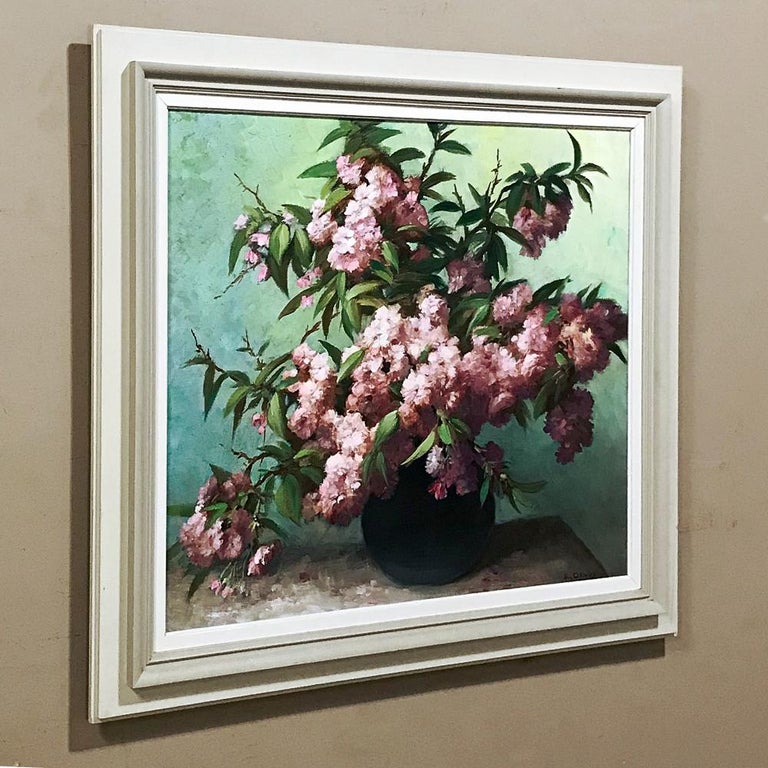 Antique framed oil painting on canvas ~ Floral Still Life by E. Devos features vivid yet pastel hues, and the artist has employed a contrasting background that creates depth and color without detracting from the sheer natural beauty of the flowers