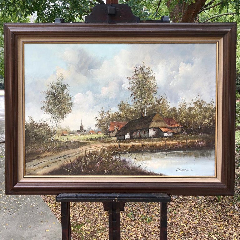 Antique framed oil painting on canvas showcases the artist's talents with rendering landscape, sky, water, even quaint rural architecture. Mounted in its original frame. The iconic scene invites one into the composition via a dirt road the forks at