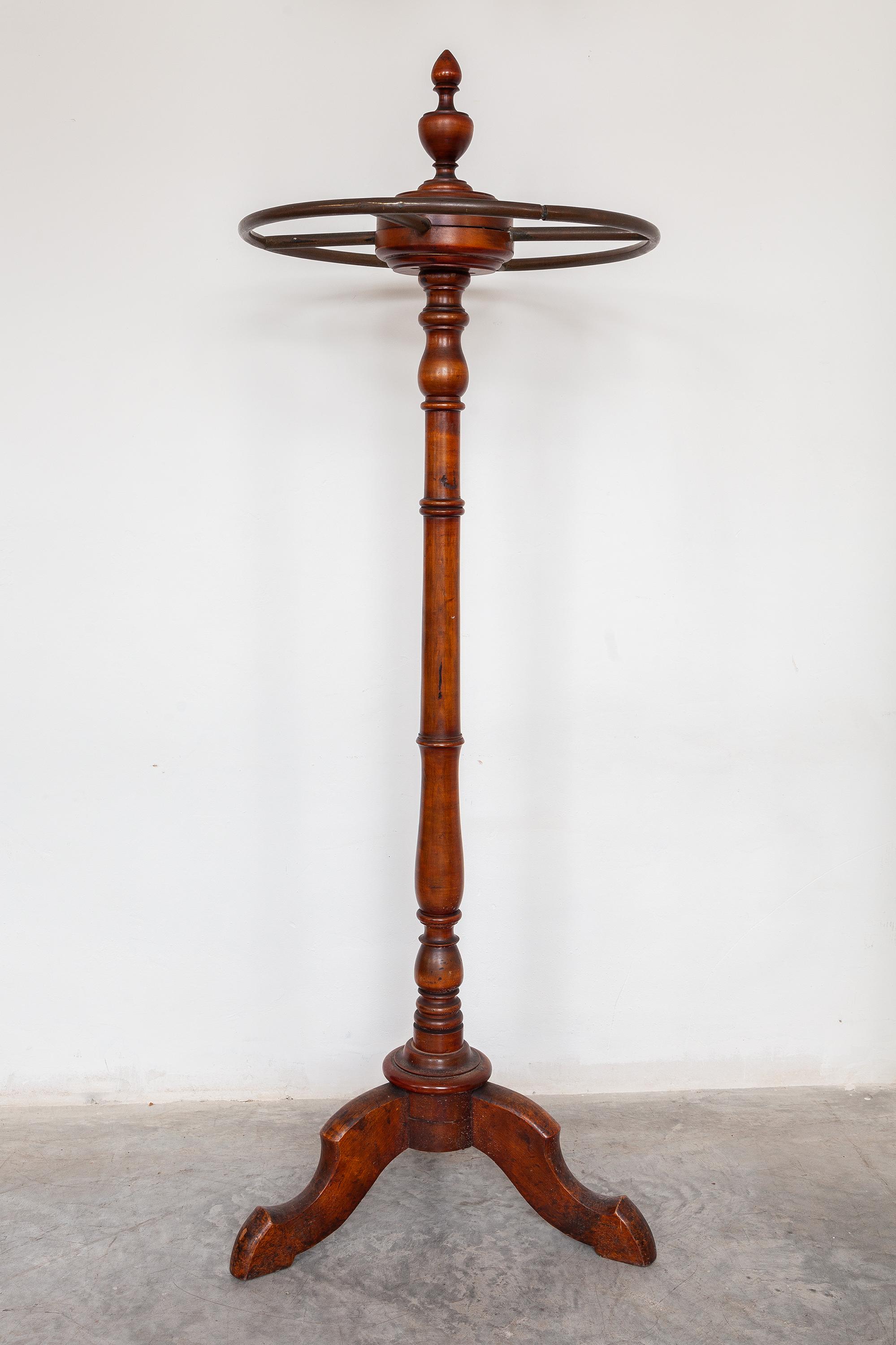 Antique coat rack. Elegant turned wood base with metal ring on which you can store coats on hangers or S hooks.
A practical freestanding and decorative storage solution to bring a touch of class to your home.