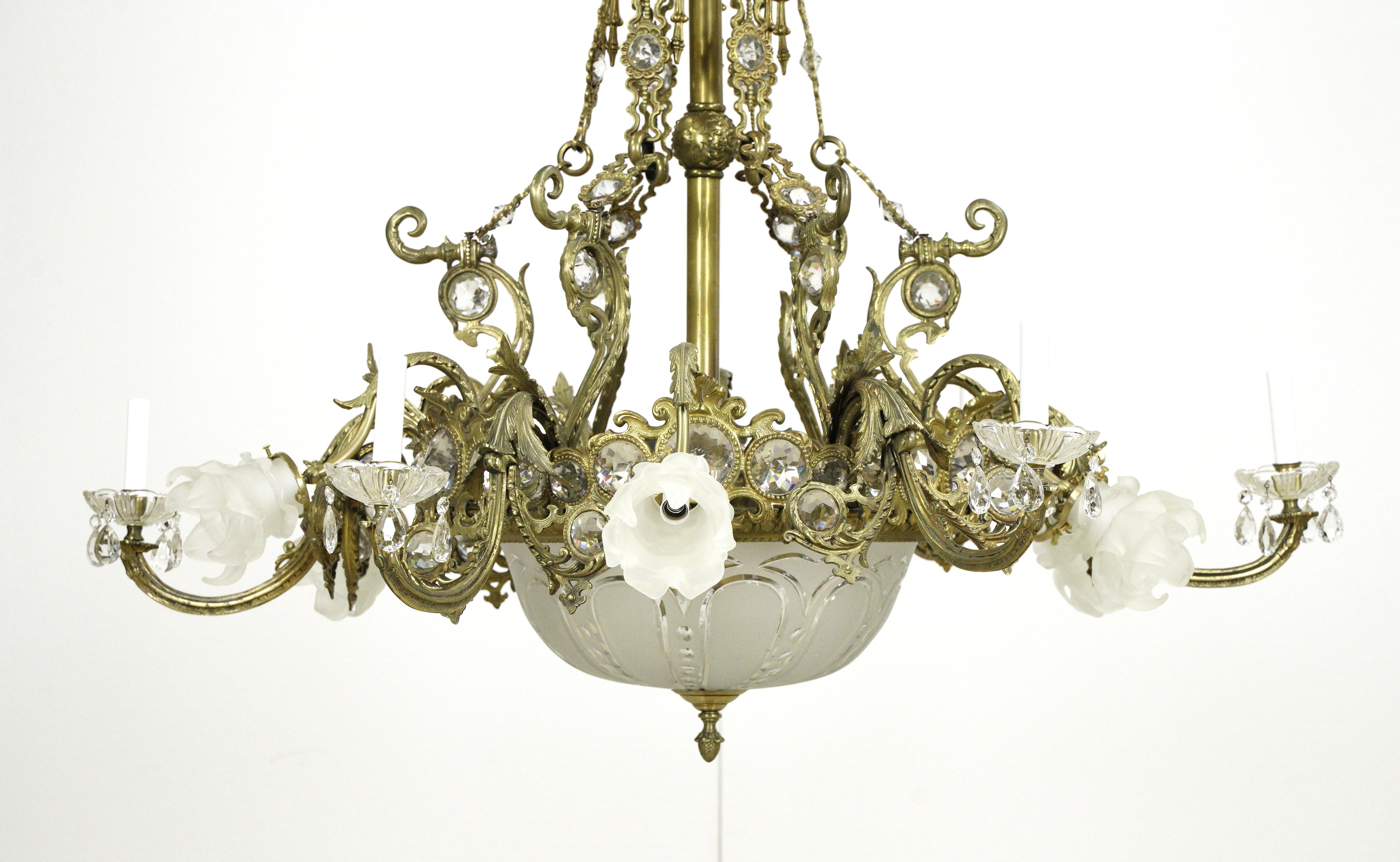 Highly ornate French bronze and crystal chandelier with an etched glass bowl and frosted glass floral shades suspended from a steel chain. This light requires 15 candelabra light bulbs. This light is wired and ready to ship. Good condition with