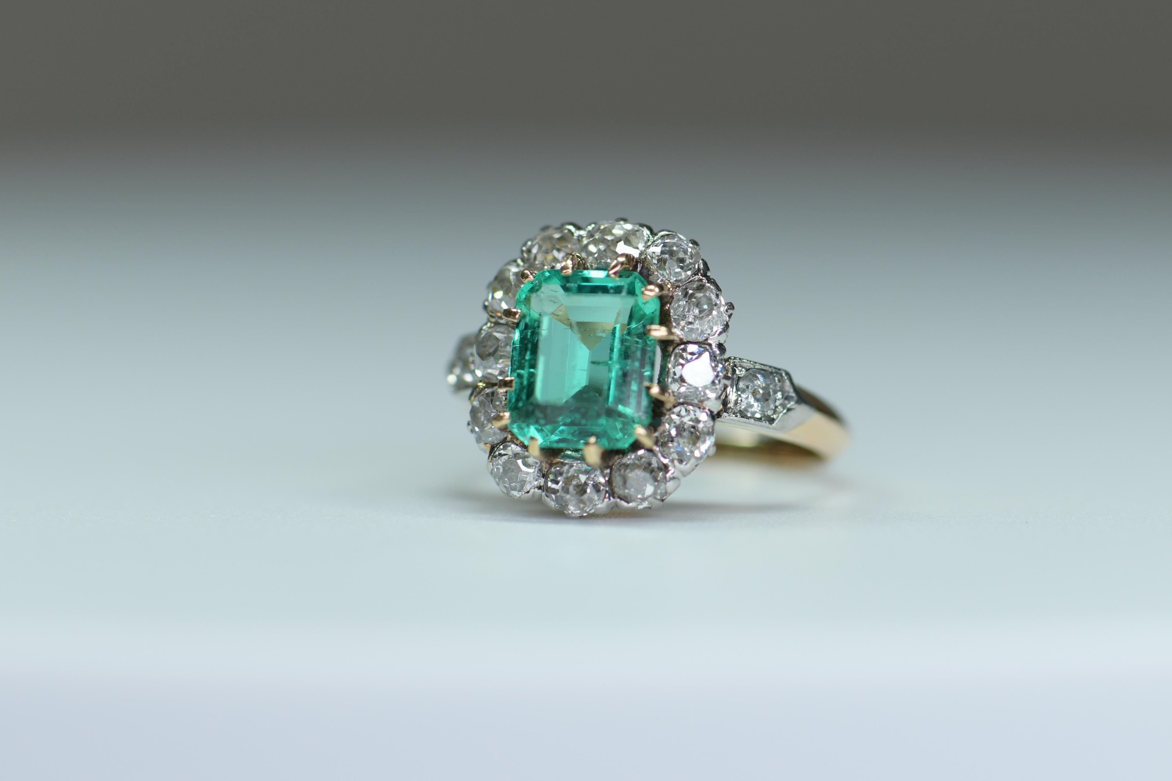 An impressive Colombia Emerald and diamond cluster ring made in 1860. It is typical of good French design and has been set with a rectangular cut Columbian emerald. It is surrounded by twelve white diamonds. It is an impressive and unusual ring that