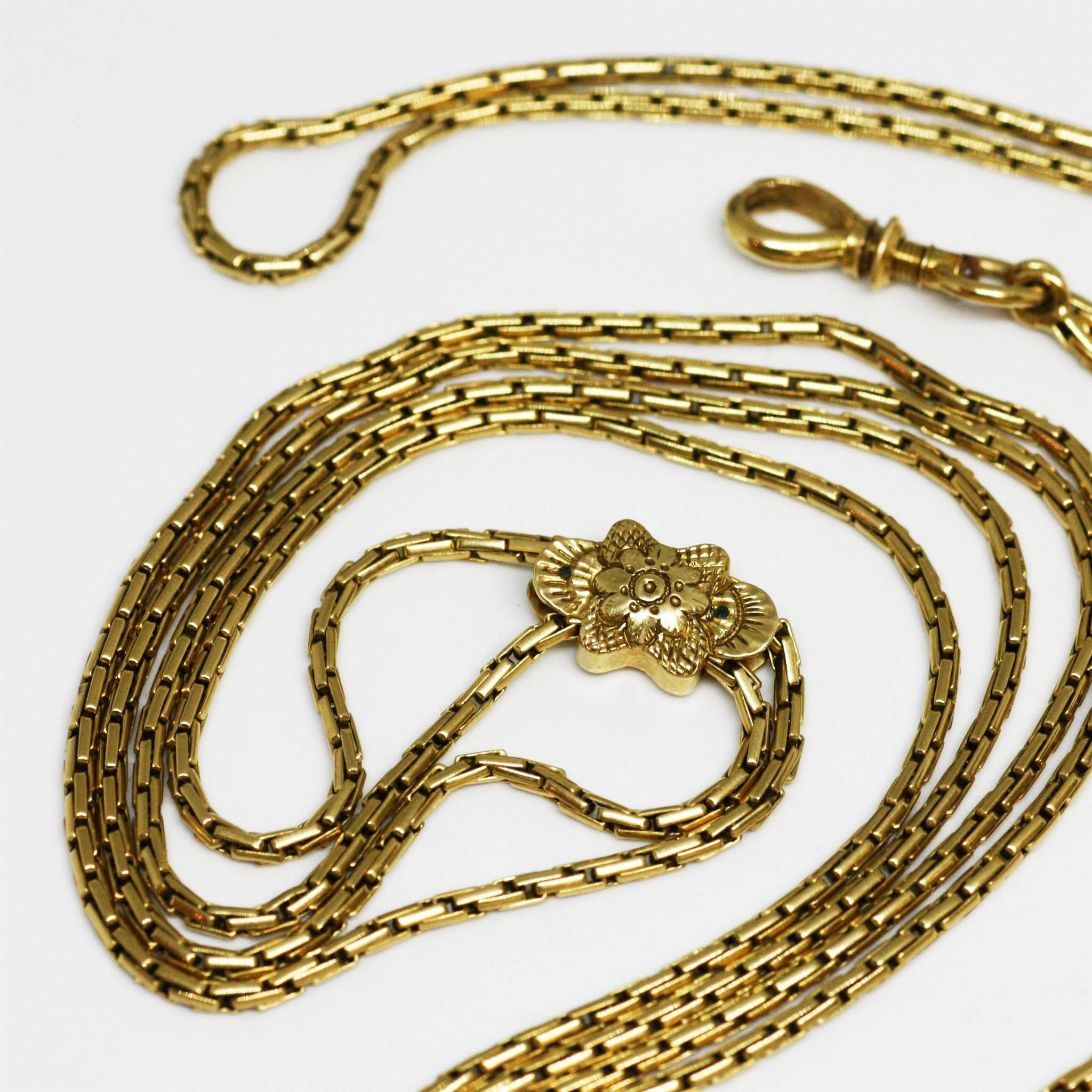 Antique yellow 18k gold long chain of a rare model. It has a movable slide decorated with a floral pattern and a security clasp. 
Perfect condition.
French (hallmark : eagle’s head), circa 1850

Length : 133.6 cms
Weight : 30.9 grs