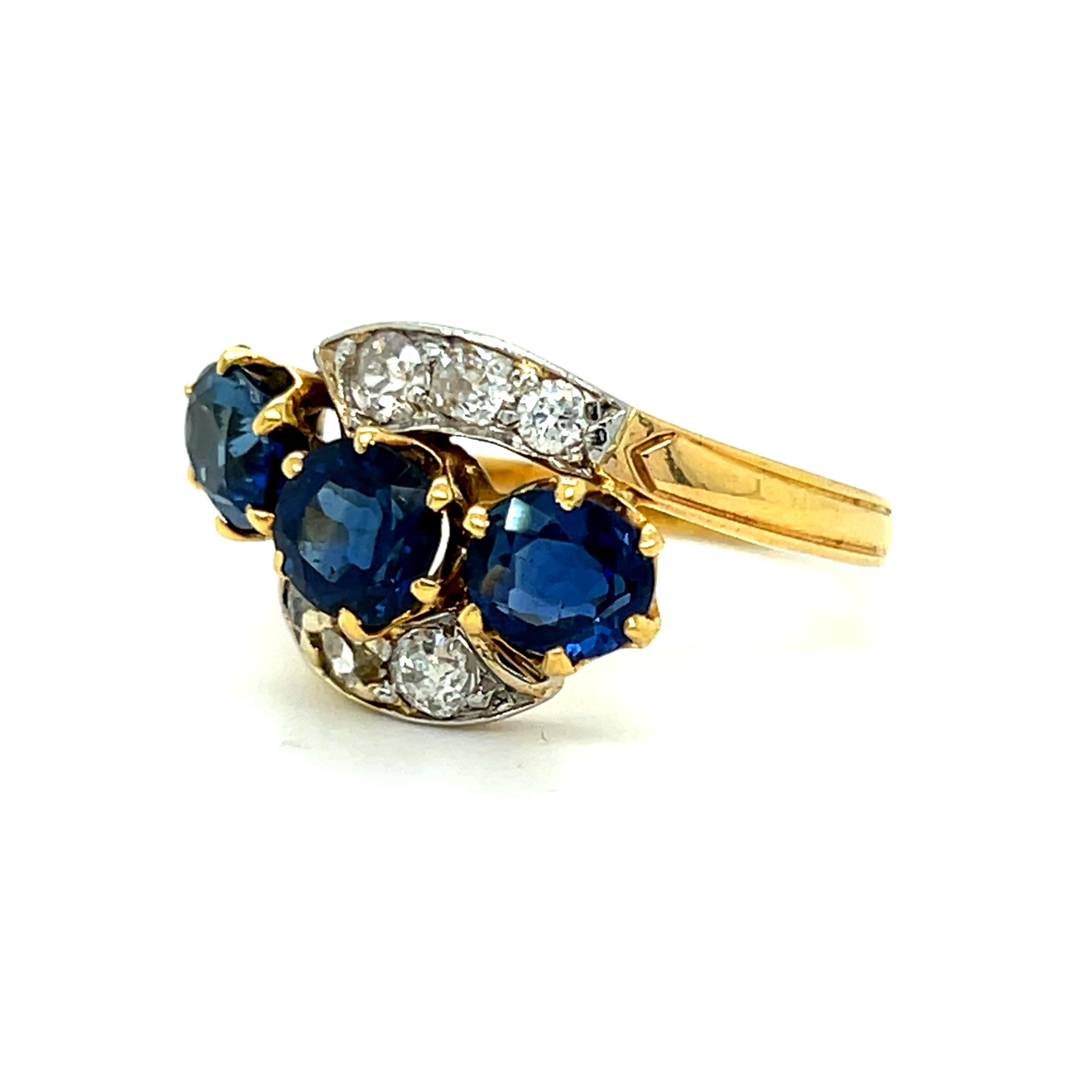 Art Deco Antique French 18K Yellow Gold Diamond and Three Stone Sapphire ByPass Ring. For Sale