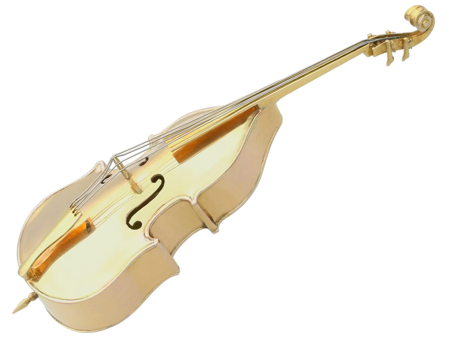 An exceptional, fine and impressive antique French 18k yellow gold ornament of a double bass; part of our ornamental silverware collection.

This exceptional antique cast French 18k yellow gold ornament has been realistically modelled in the form of