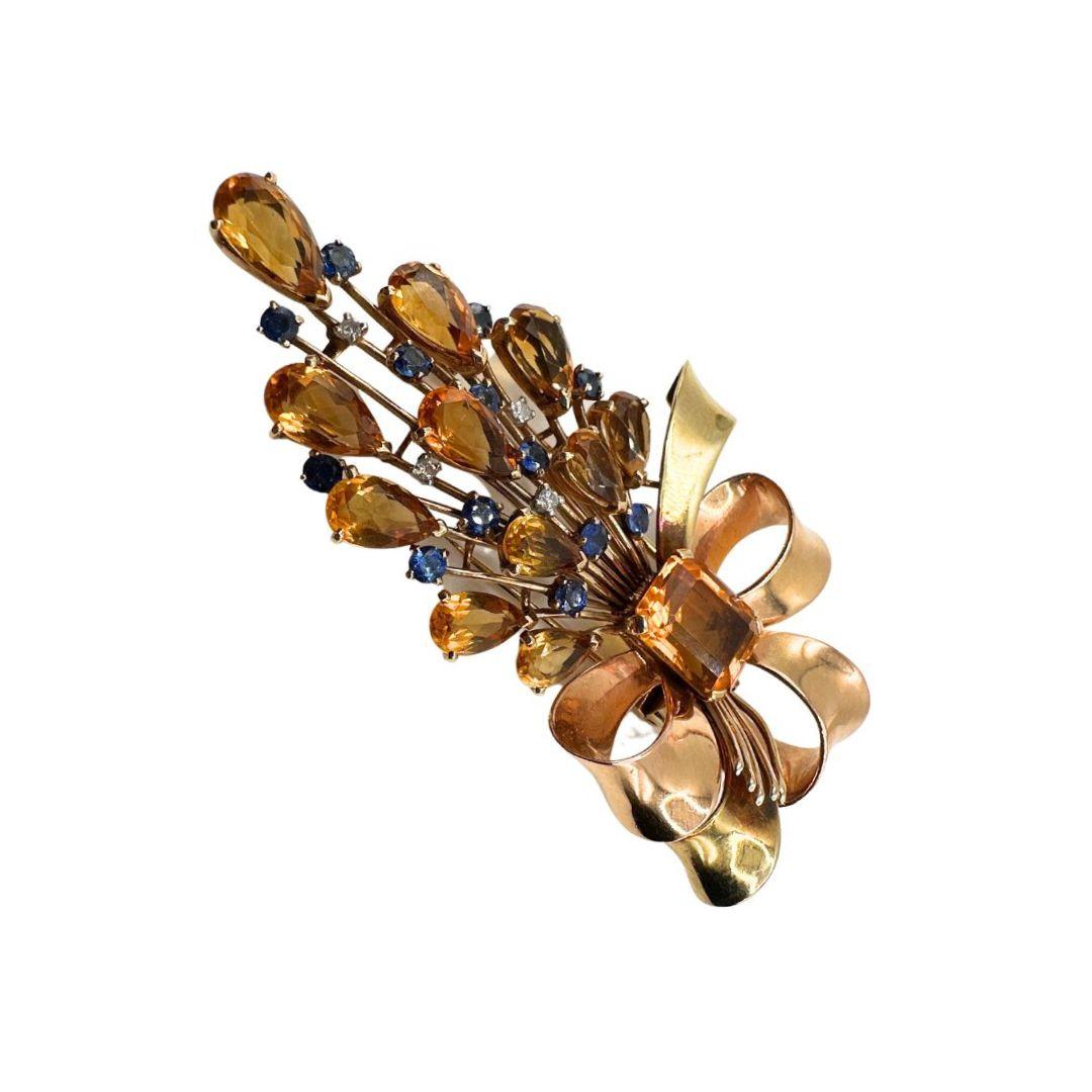 Transport yourself to the grandeur of French craftsmanship with our Antique French 18K Gold Multi-Gemstone Brooch. This exquisite piece features approximately 12 big citrines, 13 sapphires, and 4 diamonds, meticulously set in a stunning dance of