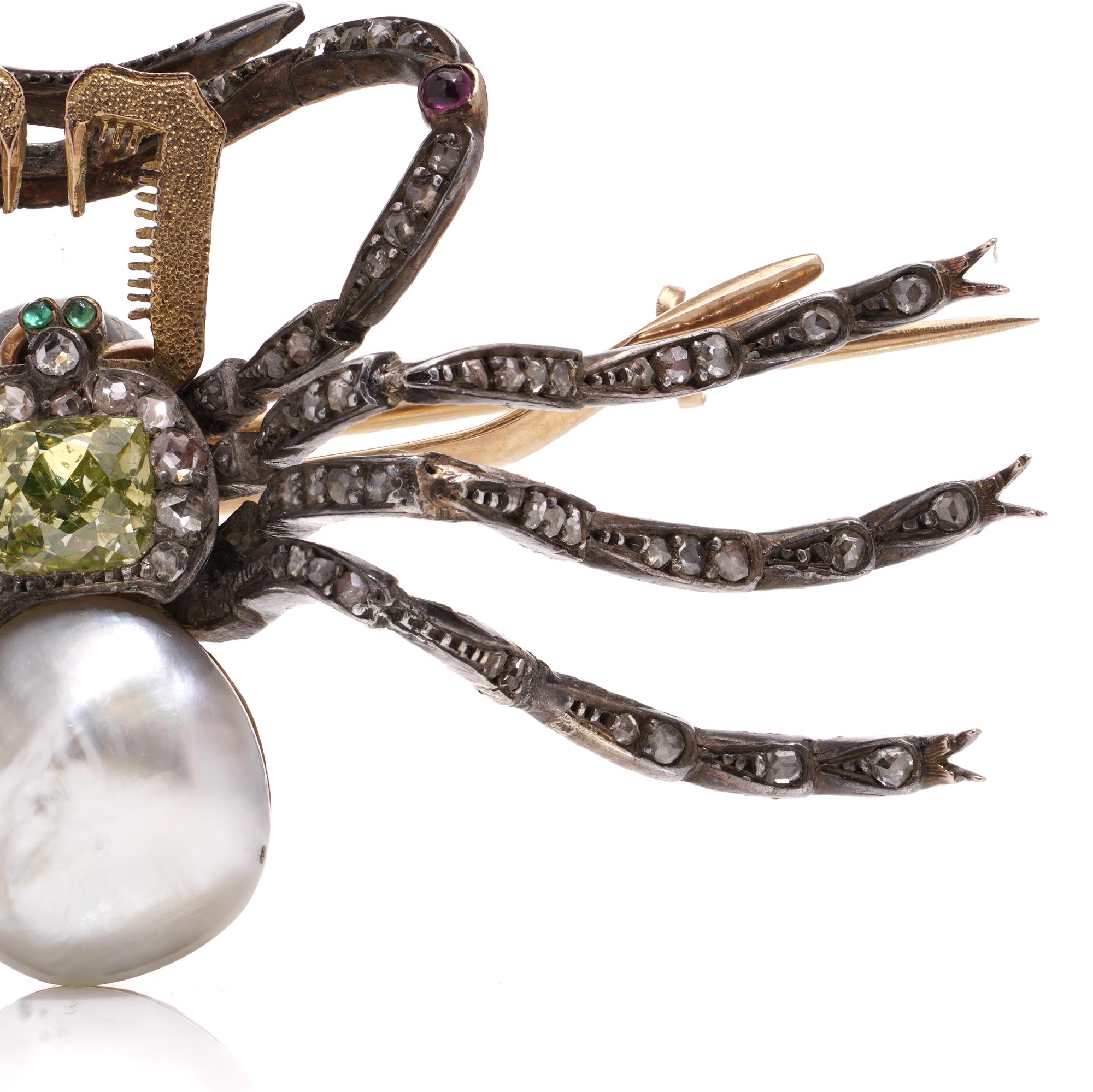 Antique French Victorian 18kt gold and silver spider brooch, crafted circa the 1890s. Featuring a cushion-cut yellow diamond body encased in a cluster of rose-cut diamonds, complemented by a bouton-shaped pearl. Its captivating cabochon emerald eyes