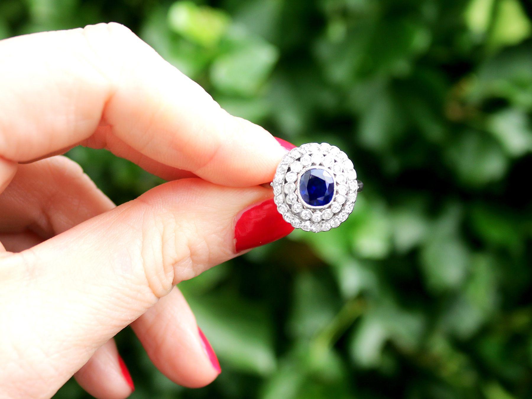 A stunning antique French 1.90 carat natural blue sapphire and 1.10 carat diamond, 18 karat white gold and platinum set cluster ring; part of our diverse antique jewelry collections.

This stunning, fine and impressive natural sapphire and diamond