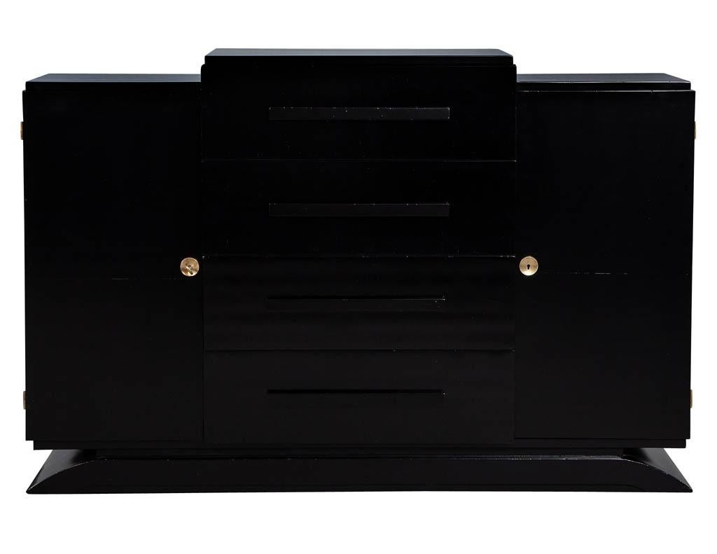 Antique French 1940s Art Deco black lacquer sideboard buffet. Unique and exquisite Art Deco French sideboard cabinet with original brass hardware and keys, recently restored in a rich satin black by our master craftsmen. Cabinet has two cabinet