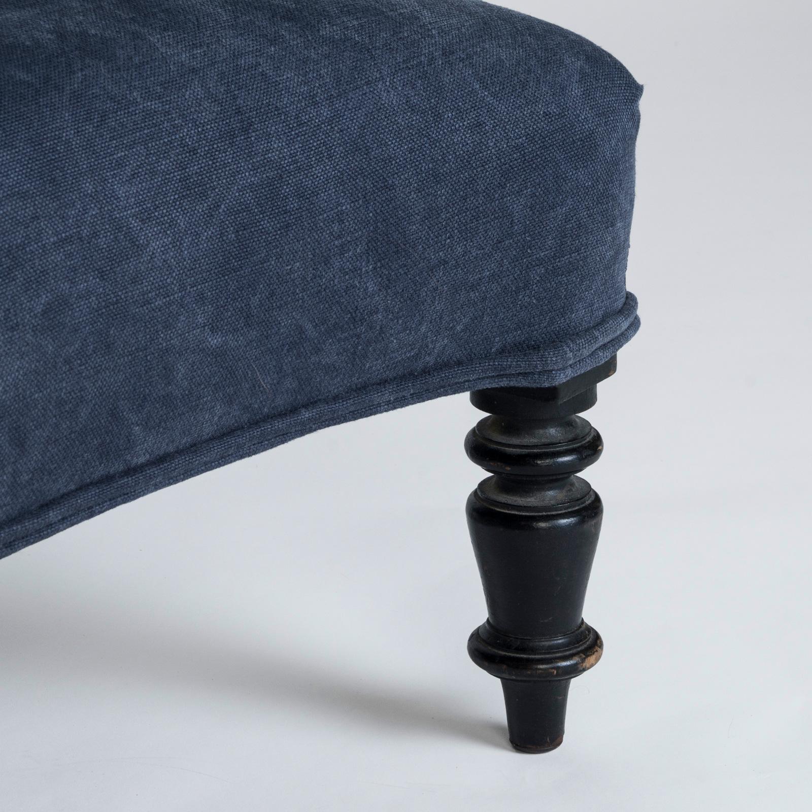 Refined 19th Century Napoleon III Style Stool or Foot Bench with a distinctive blue linen upholstery.

This exquisite stool serves as a comfortable complement to any sofa, doubling as an additional seat when needed. The upholstery has been recently