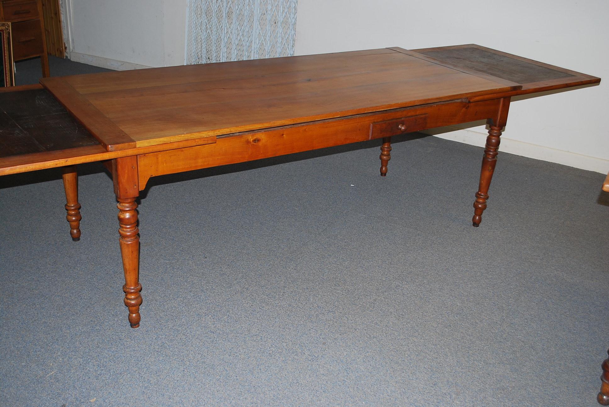 A good quality French solid cherrywood farmhouse table, with extending slides framed in cherry with chestnut centres. That can either be pulled out as work surfaces or used for additional seating (but don't go level). Standing on good quality turned