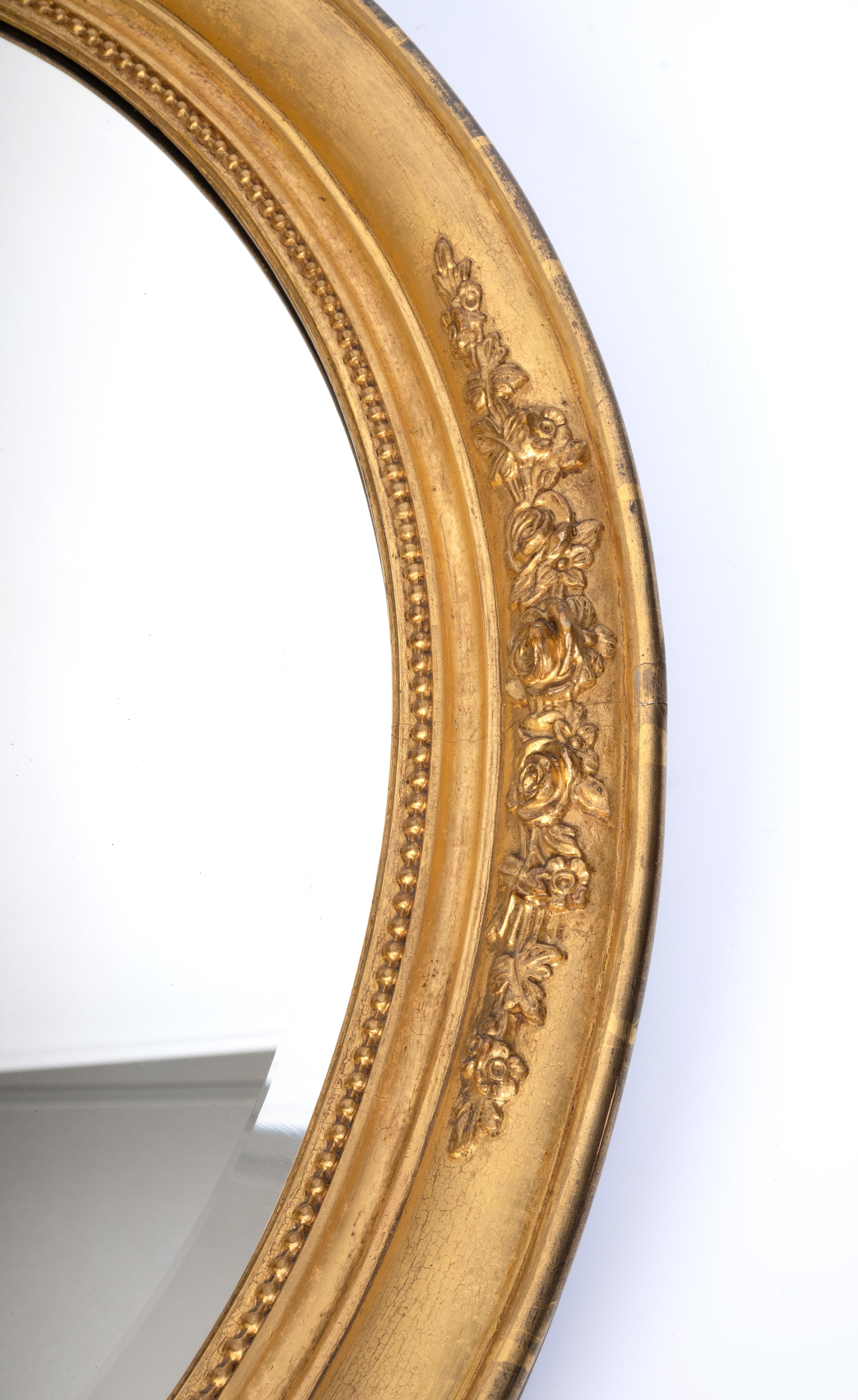 Antique French 19th Century Deep Cushion Framed Oval Gilt Mirror C.1880
Bevelled mirror and cushion frame with relief floral sprays and bead moulding.
In very good condition, with minor signs of wear commensurate with age.

68cm x 58.5cm