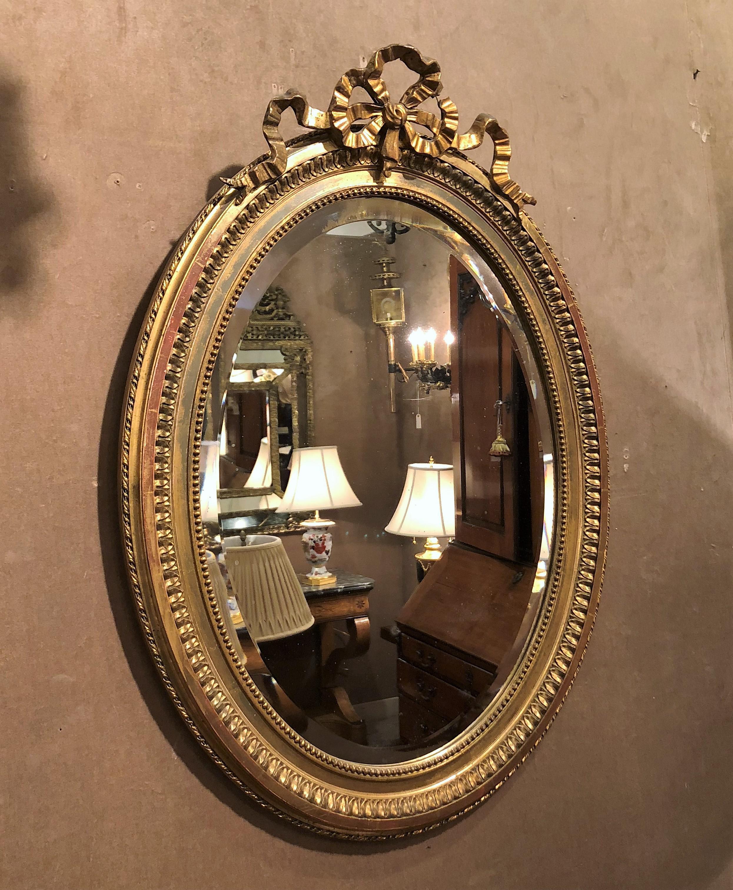 Antique French 19th century gold mirror with beveled glass.