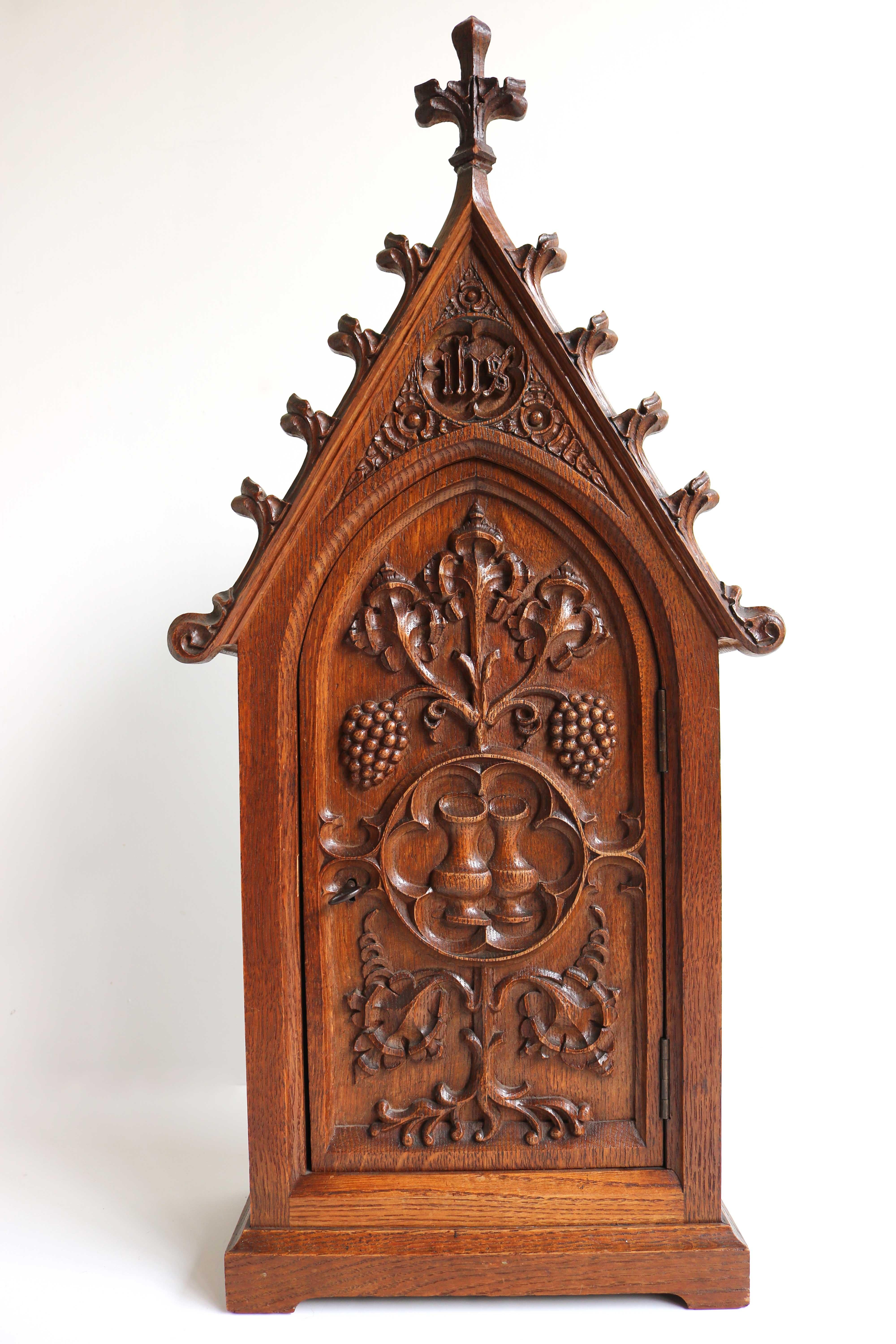 A high quality piece! 
Very rare & marvelous 19th century Gothic Revival standing cabinet / small (wall) cabinet .
The cabinet is richly decorated with Gothic style carving. 
The letters at the top IHS refer to the first three letters of the name