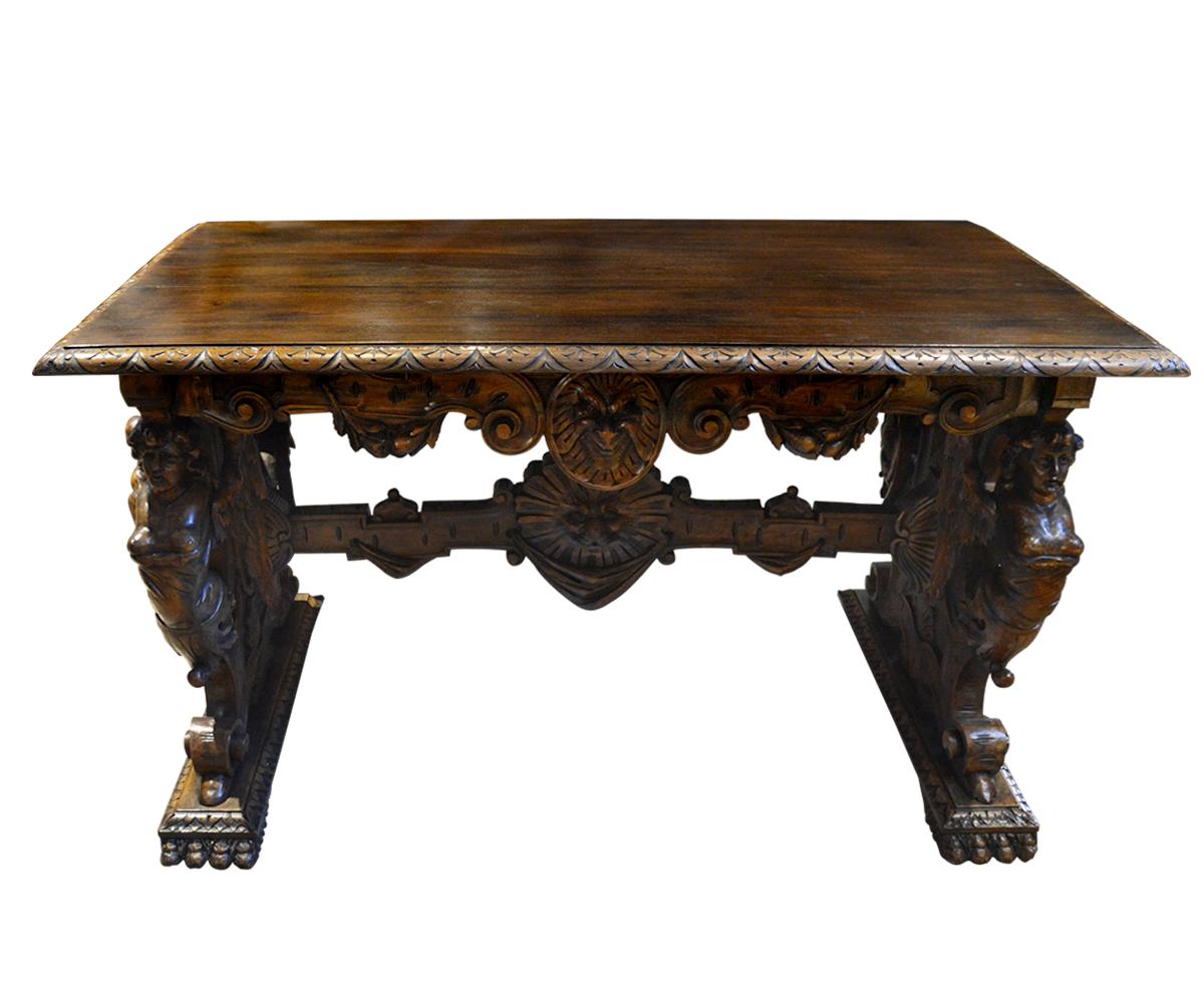 Magnificent hand-carved walnut table with exquisitely detailed angels that are very rare and unusual in the fact they are of immense size and the 3D nature of the wings which are separate from the main carving on the table. This is very versatile