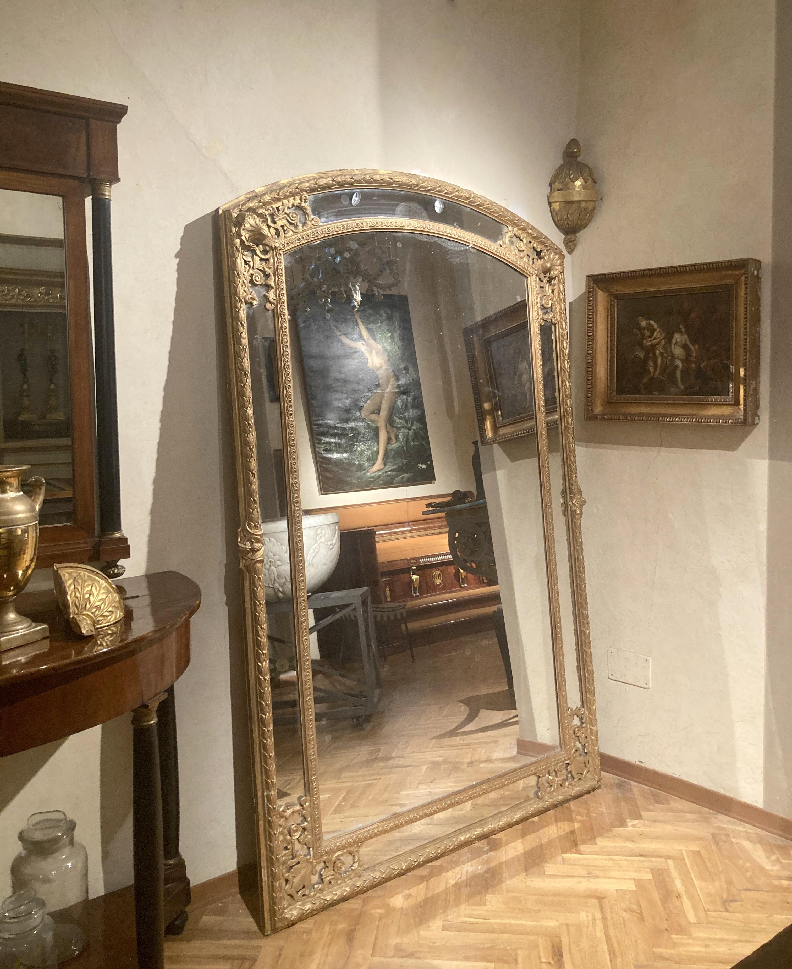 A rare pair of antique French 19th century Louis XV style giltwood round top shaped mirror with lovely gilded finish, original mercury plate and panelled backing. 
Displaying well both floor standing or wall hung, these full lenght mirrors show