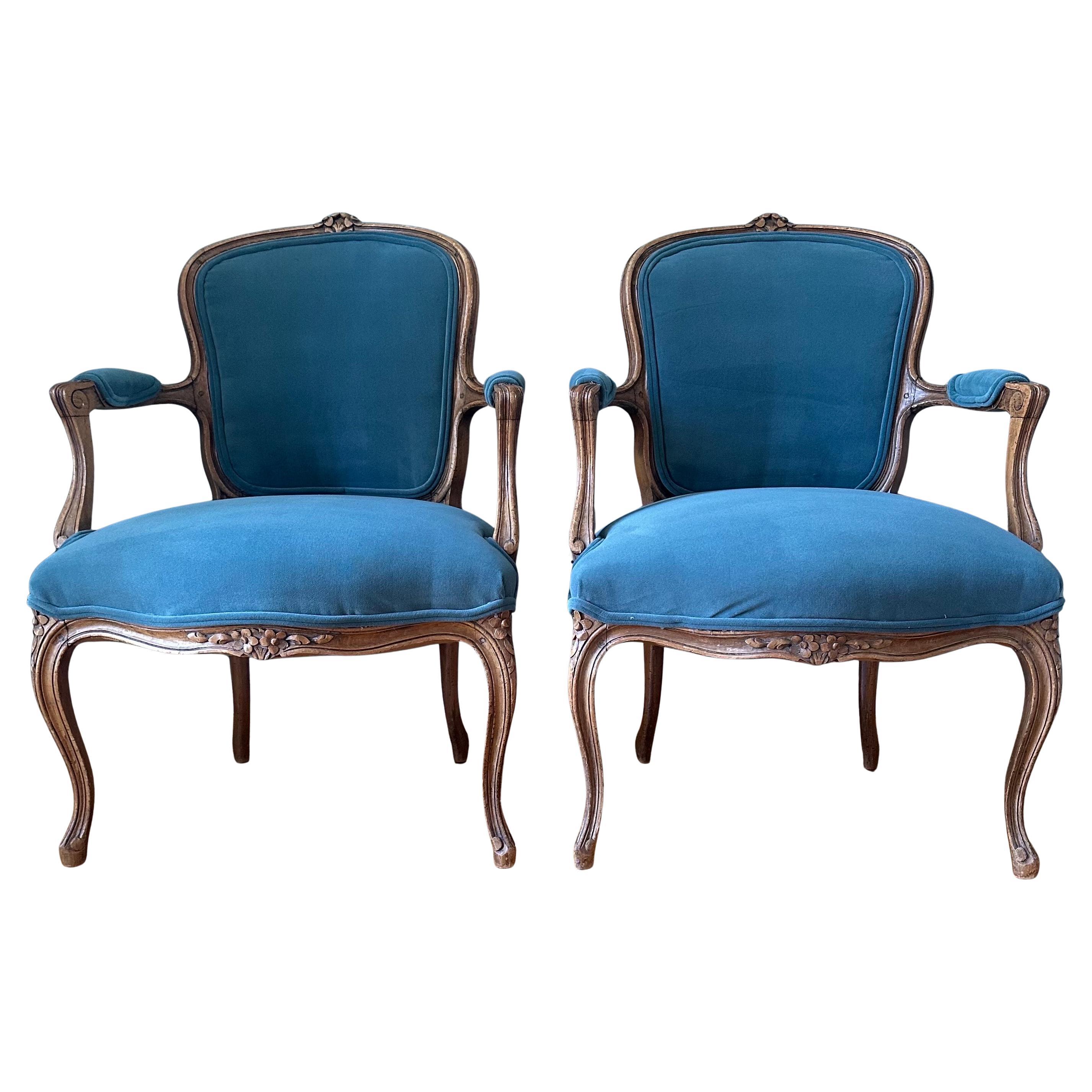 Pair of antique hand carved pegged construction Louis XV French armchairs. Pegged construction joinery technique on pair of chairs which faded from use in early 1800s. Newly recovered in velvet. Velvet is a close match to FB Inchyra Blue. The old