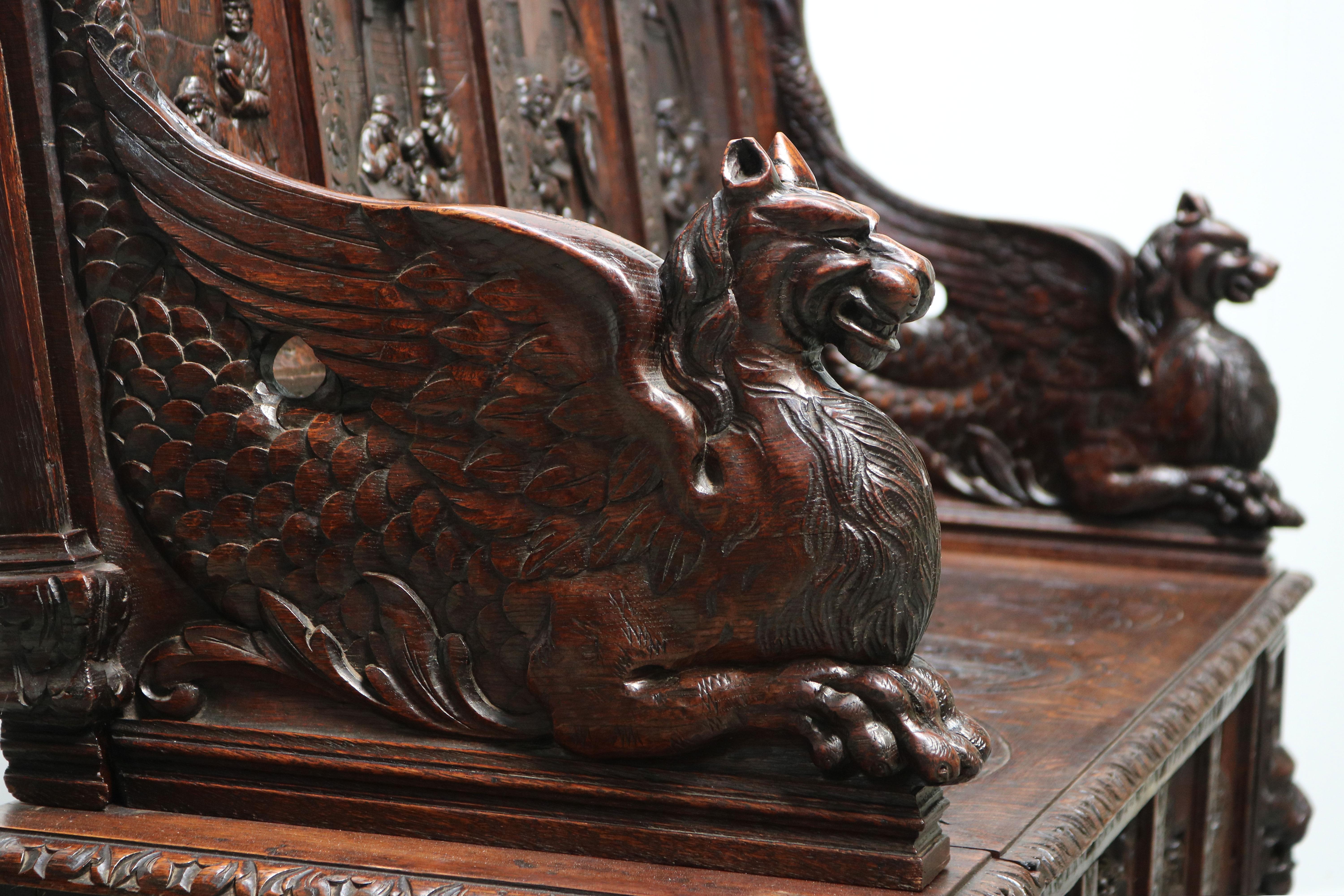 Most impressive & luxurious! This 19th century French antique Renaissance Revival / Breton style Hall bench with Impressive Gryphon armrests. 
Carved out of solid oak with numerous details & decorations all done by hand by a master carver. This