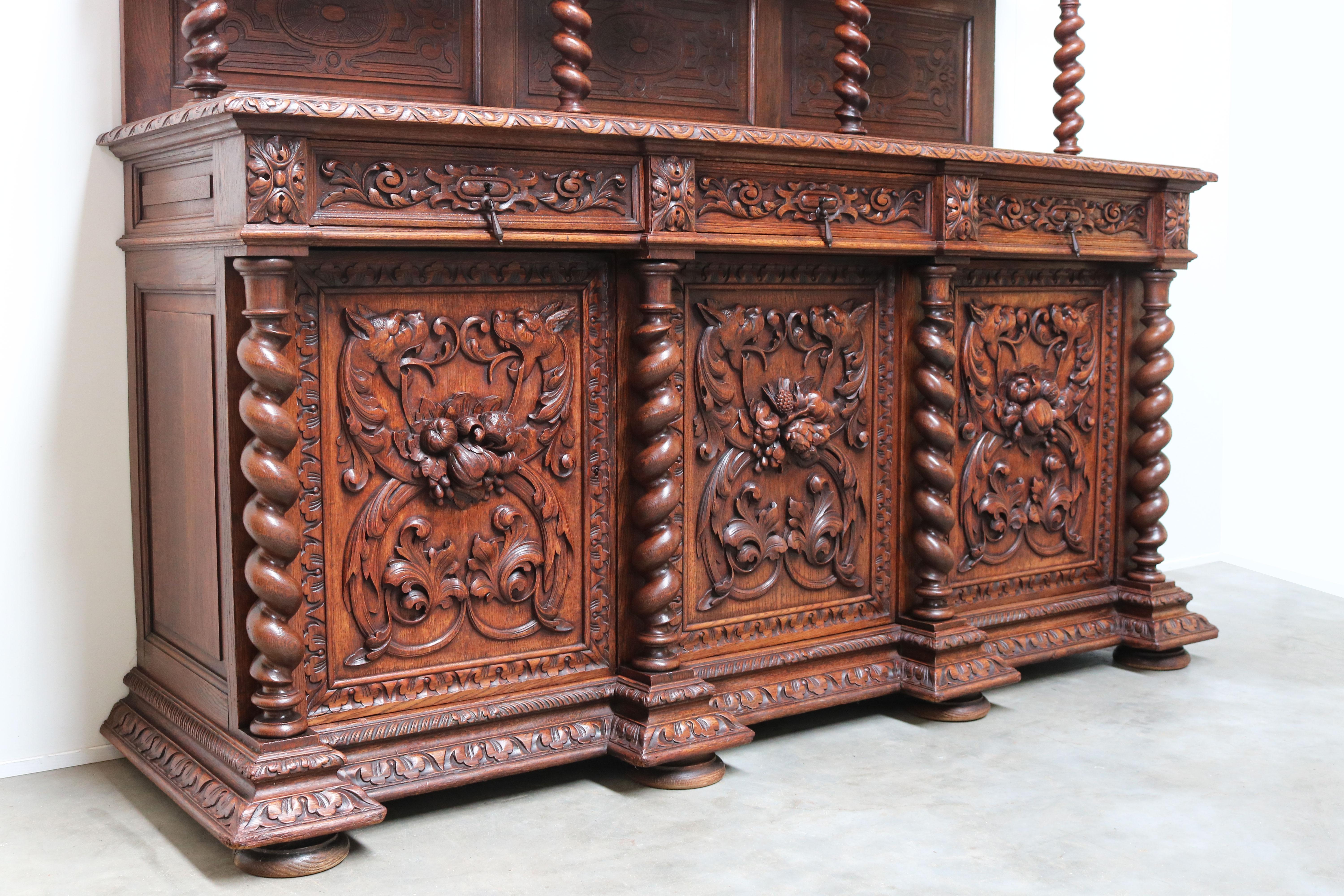 One of the most impressive sideboards we ever had the pleasure of selling in our store. 
This marvelous French Renaissance revival sideboard with a stunning amount of 12 barley twisted pillars. 
Impressively carved doorpanels with 6 dragons in