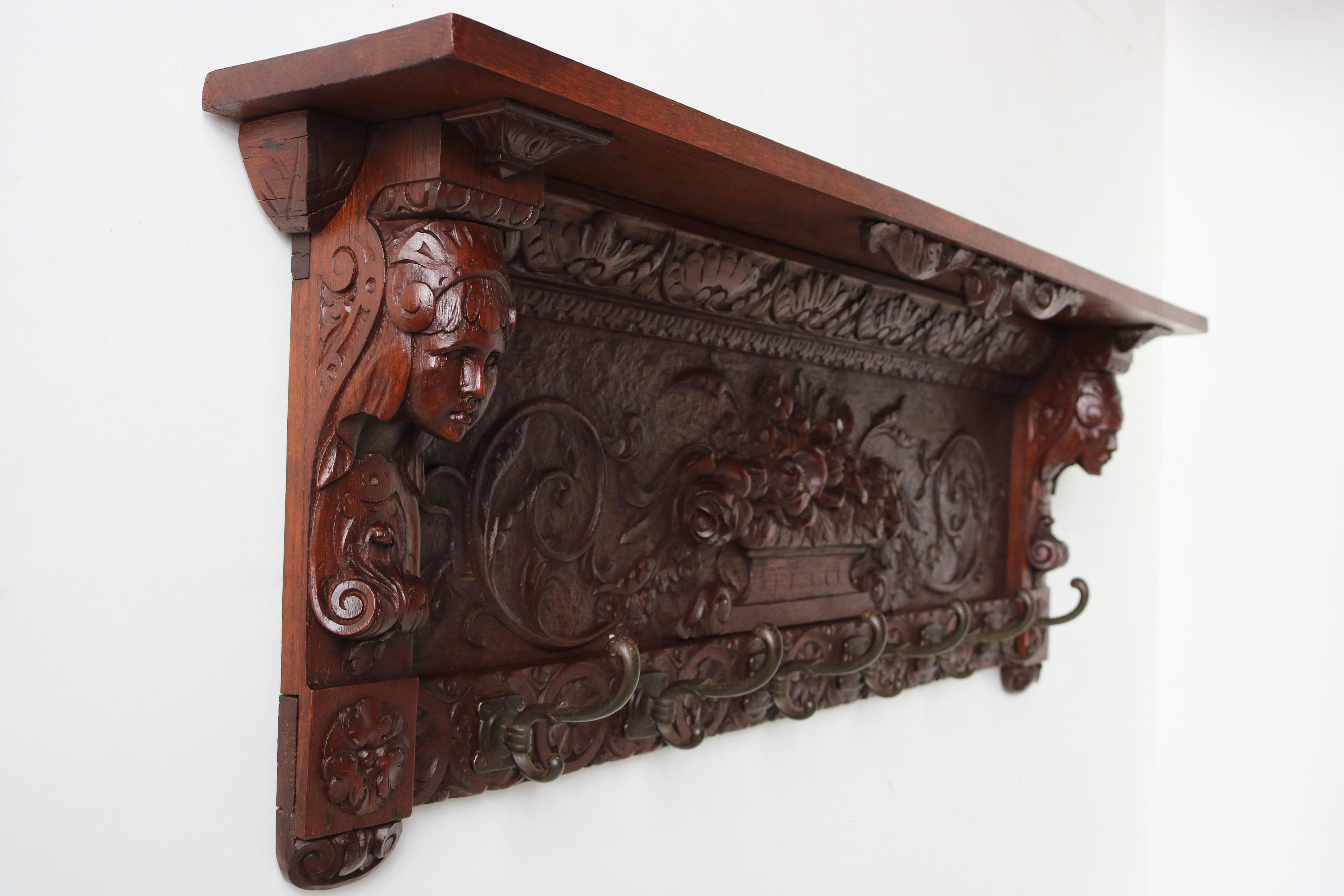 Impressive & gorgeous! This antique French 19th century Renaissance Revival coat rack in solid oak , fully hand-carved. 
Made out of solid European oak hand-carved by a master carver with much attention to detail. For example the 2 head sculptures