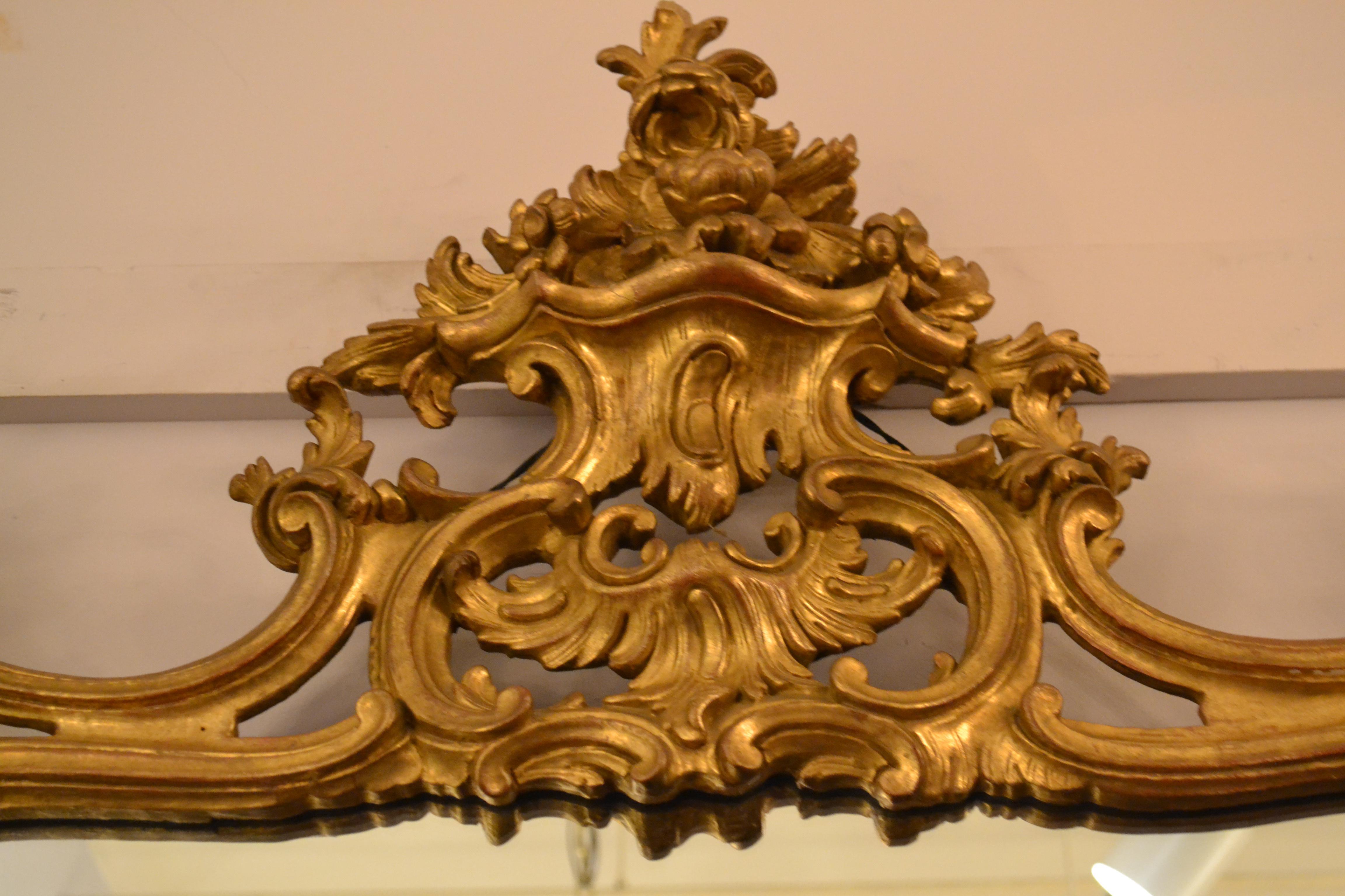 Antique French 19th century Rococo gold leaf mirror.