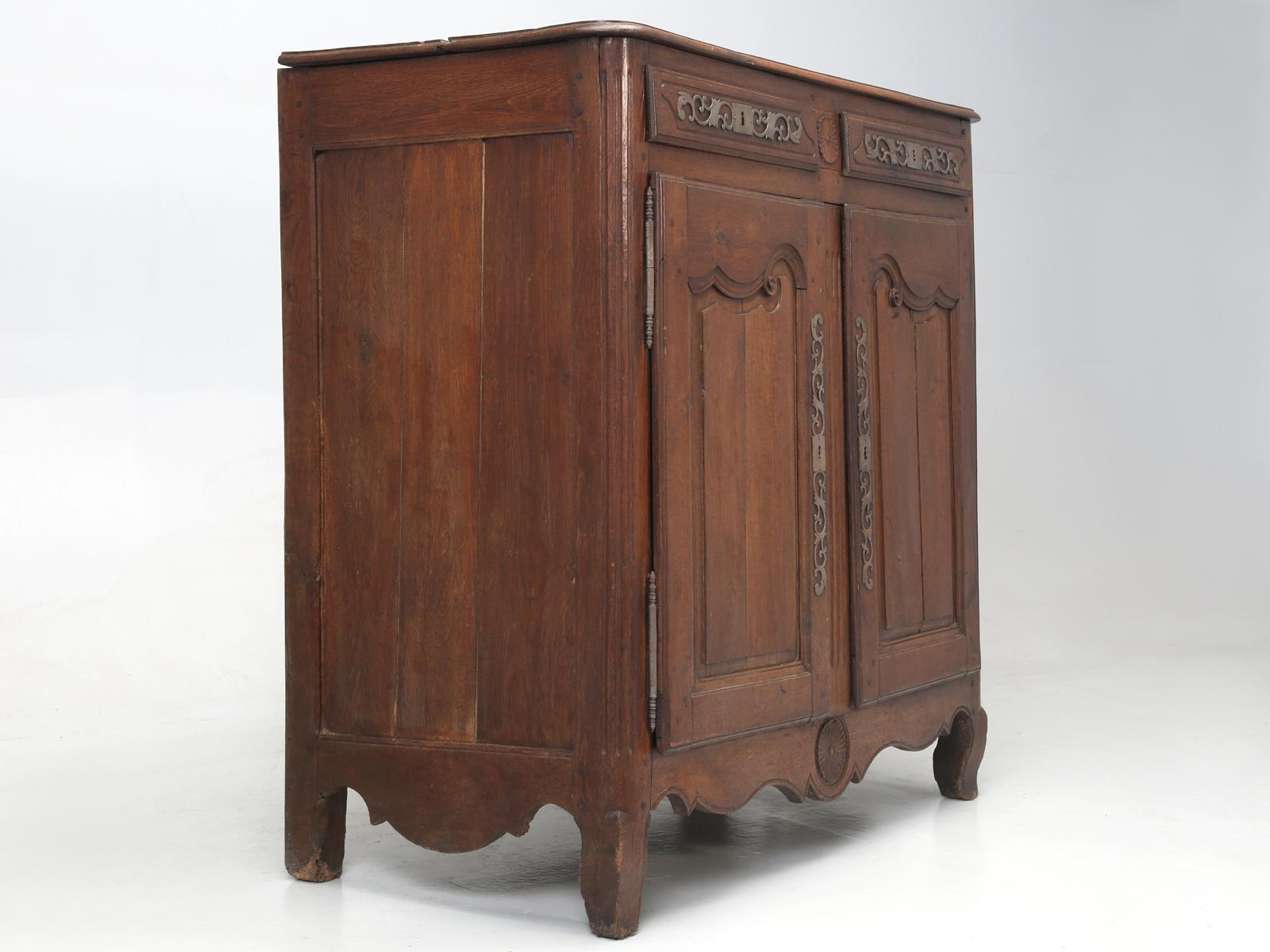 Antique French 2-door buffet, that was made about 200 years ago from French white oak. We are offering the buffet, in as found condition and it does require some restoration. This particular antique French buffet, is typical of the condition you