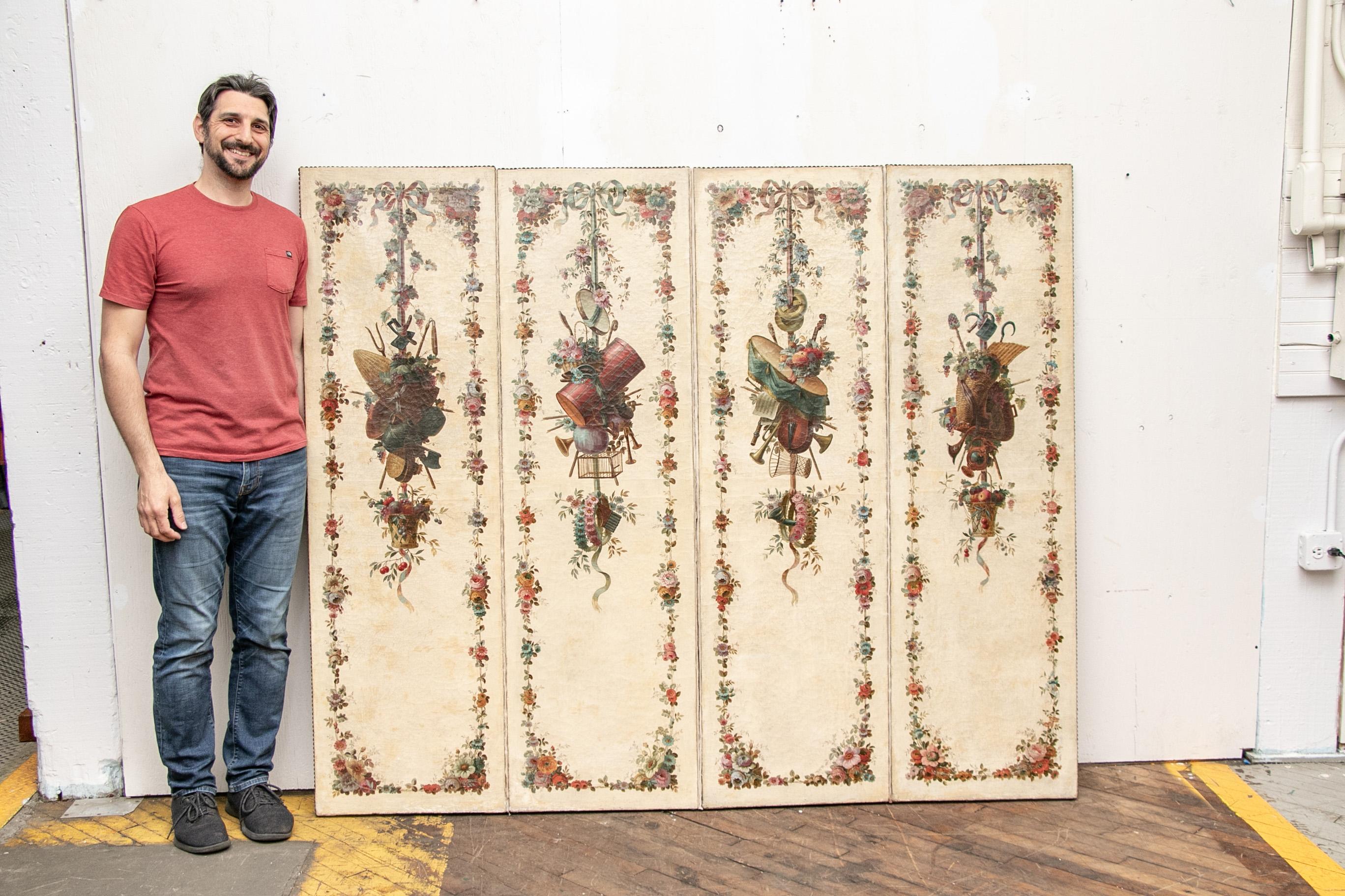 Hand painted in great detail four panel continental screen in a classical musical four seasons floral motif. Now mounted as a single unit to be hung on a wall (no longer folded). Nailhead trim to perimeter.

Condition: Good condition with expected
