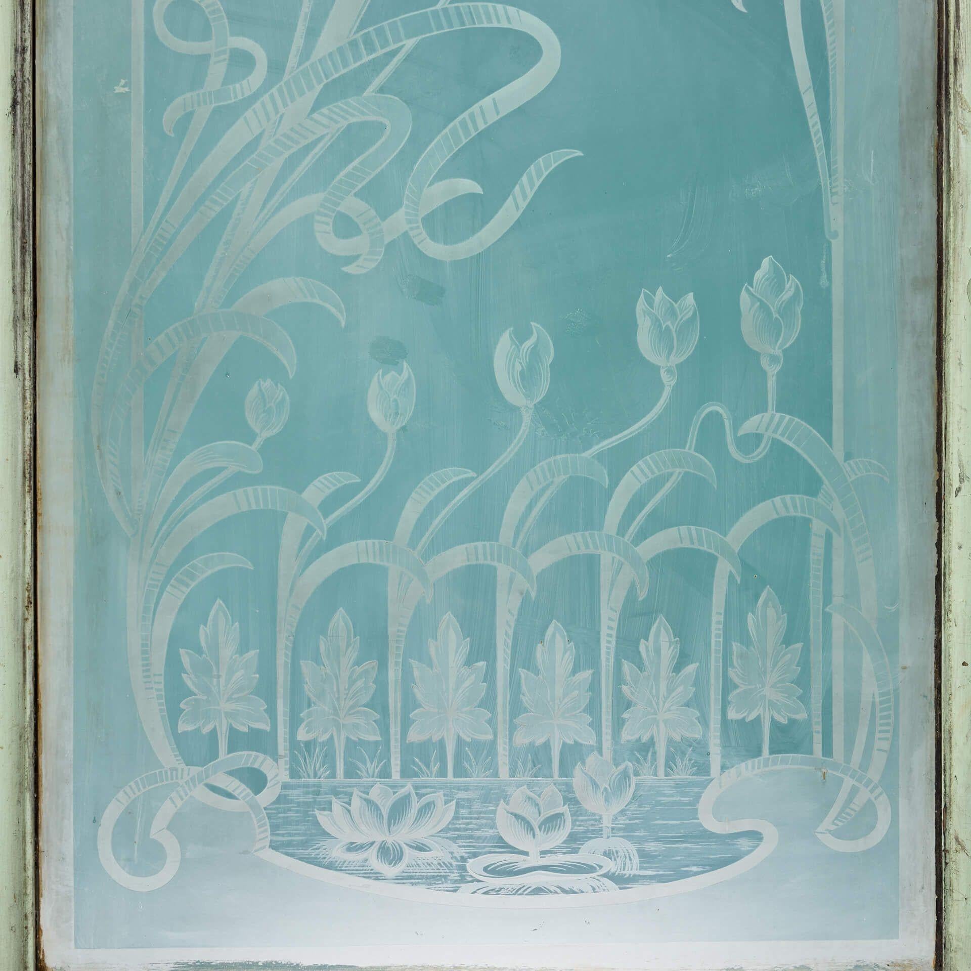 An antique French acid etched painted pine door. Suitable for interior use, this striking door is artistically glazed with acid etched glass depicting water lilies, also known as water nymphs. It makes a handsome internal door for a sunroom, kitchen