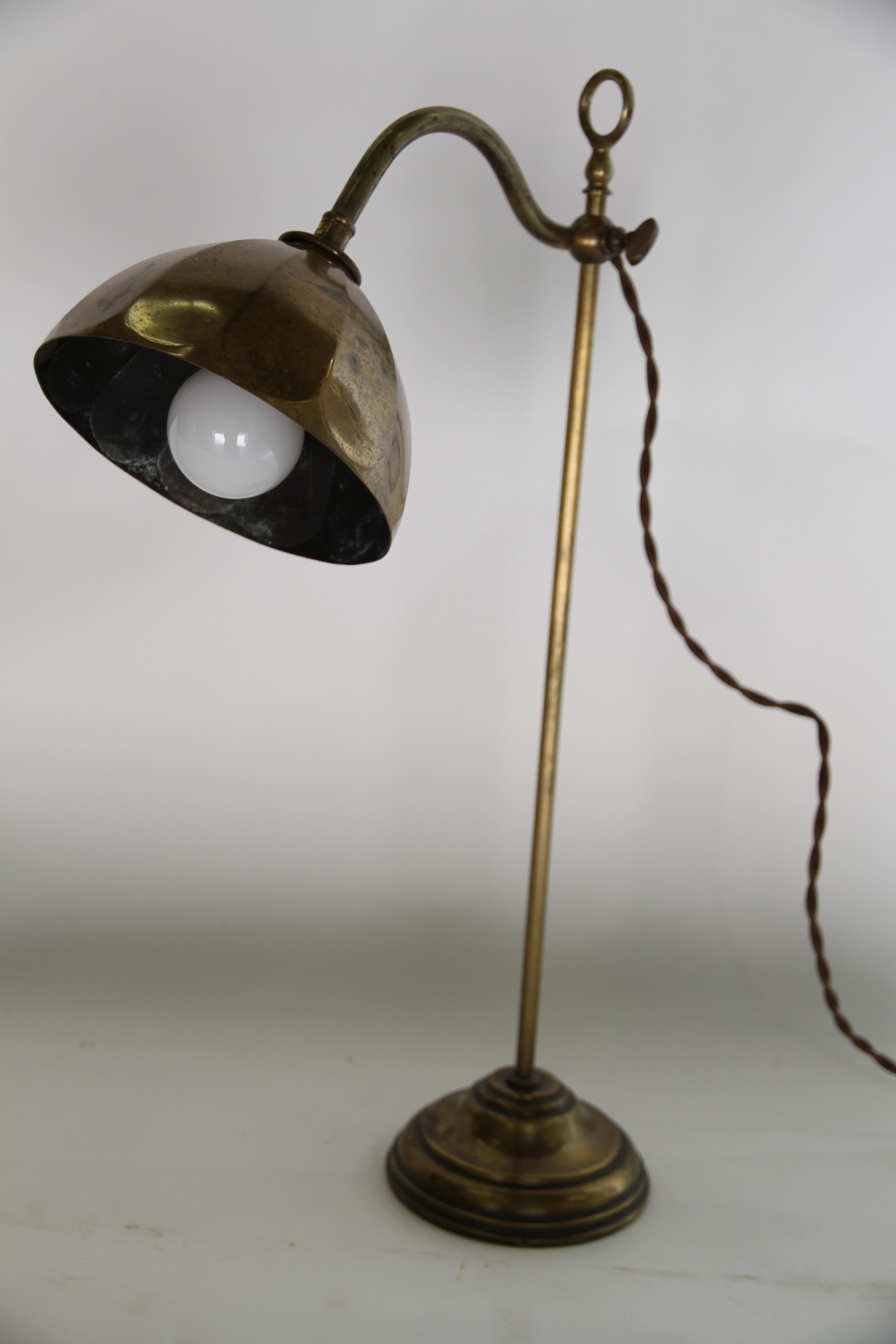 A lovely antique French brass lamp. This lamp has been newly wired to U.S. standards, the arm of the lamp is adjustable, up and the pole with a slide mechanism. Perfect as a desk or reading lamp.