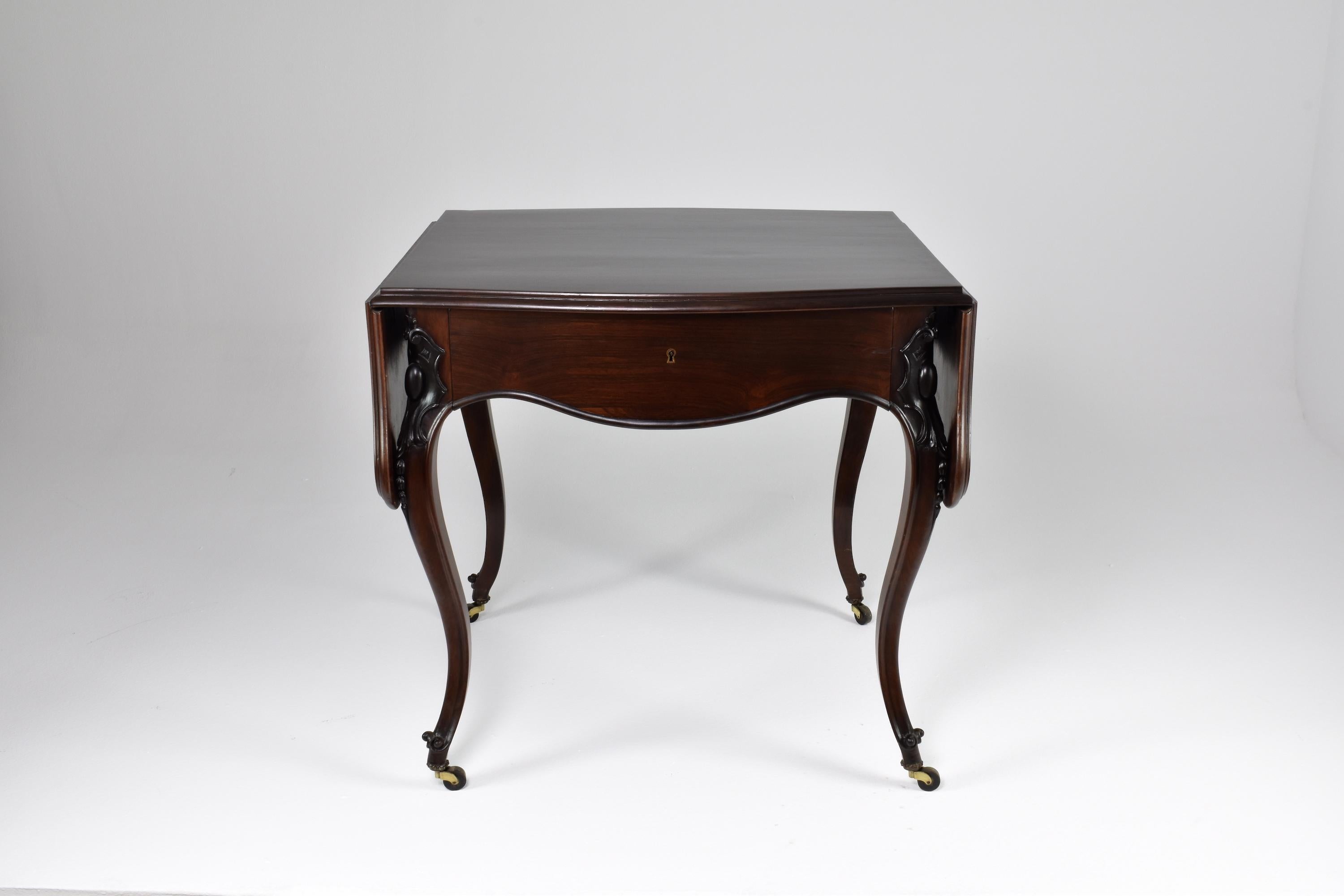 An antique St Louis XV centre table handcrafted with an adjustable foldable, tabletop ; a large central drawer; and brass rollers. 
This piece combines practicality and elegance, the rectangular top can be folded down to create a smaller surface