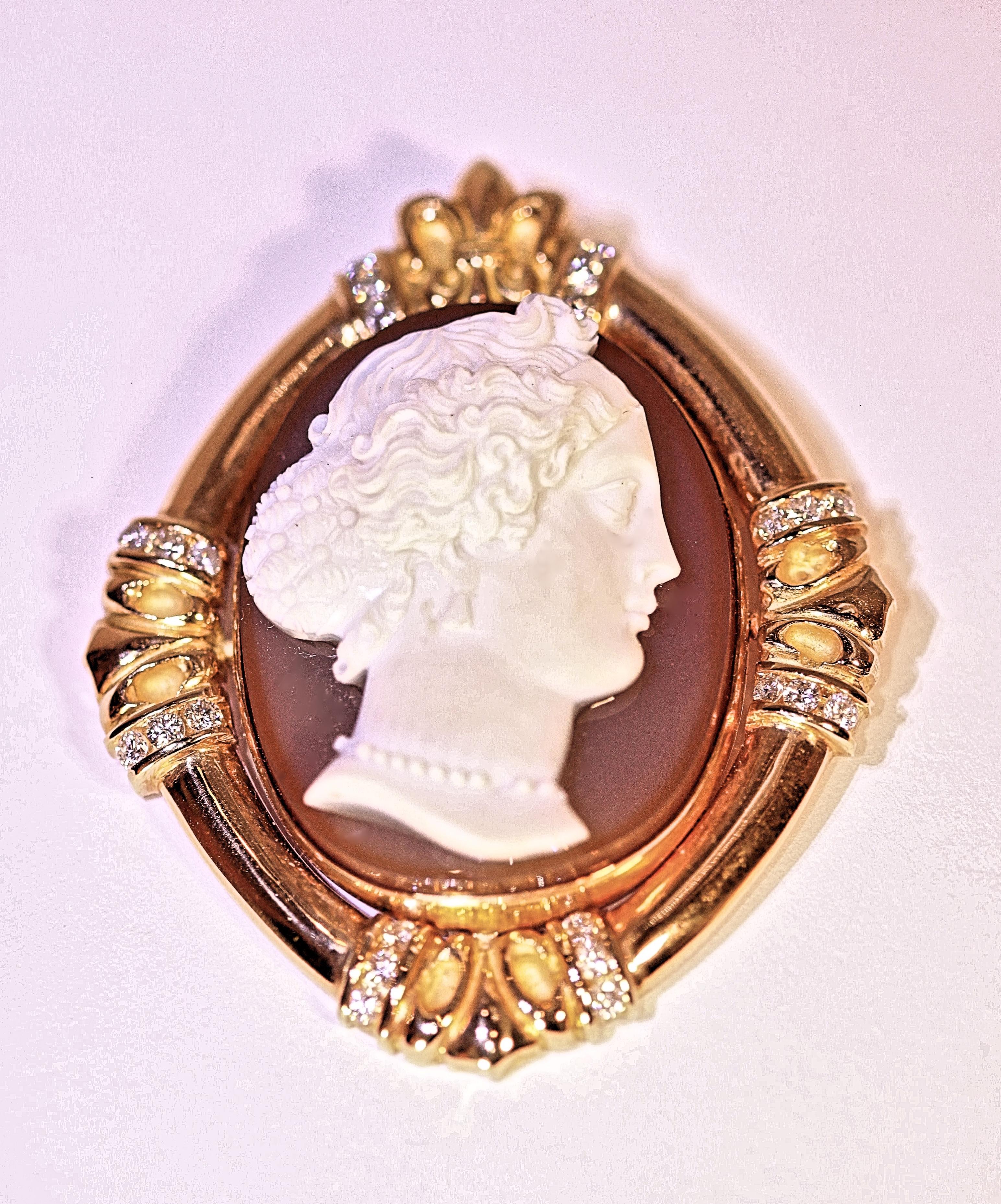 A piece from my personal collection and one of my favorites.  When worn, it was truly a conversation piece.  The center is an`antique French agate cameo surrounded by 18 karat 
yellow gold with accent diamonds.  The pendant is beautifully hand made