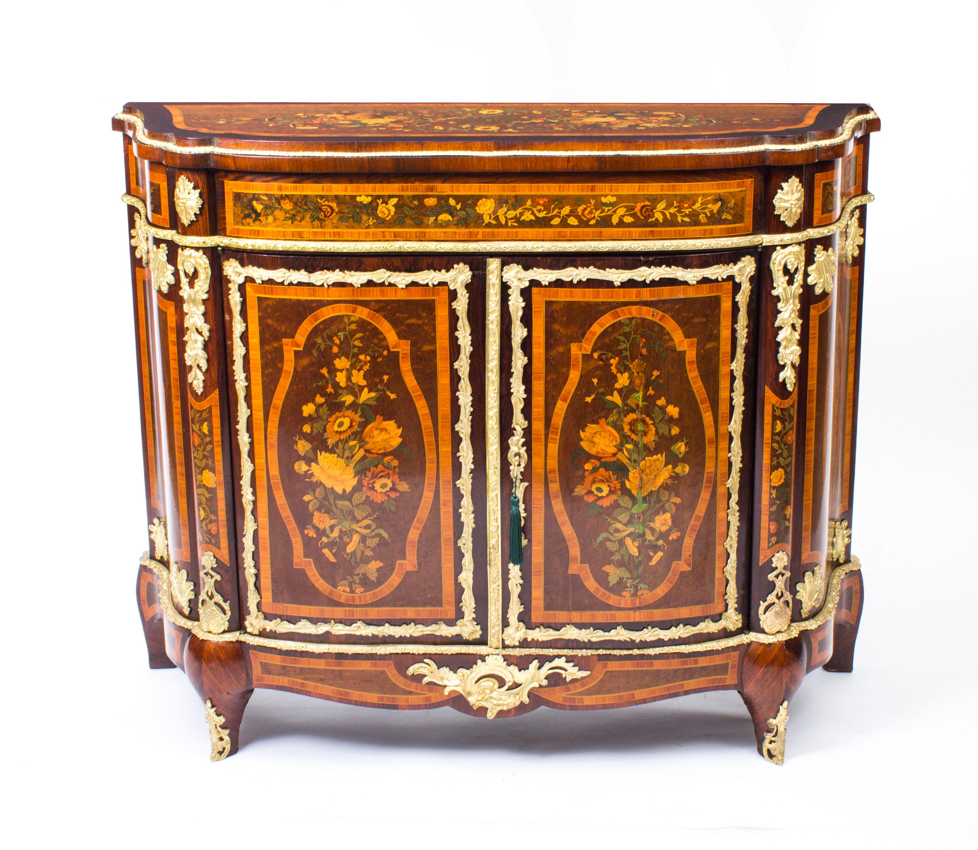 This is a superb and imposing antique French ormolu mounted, amboyna and marquetry side cabinet, C 1850 in date.

The entire piece highlights the unique and truly exceptional pattern of the floral marquetry which is set into the amboyna ground