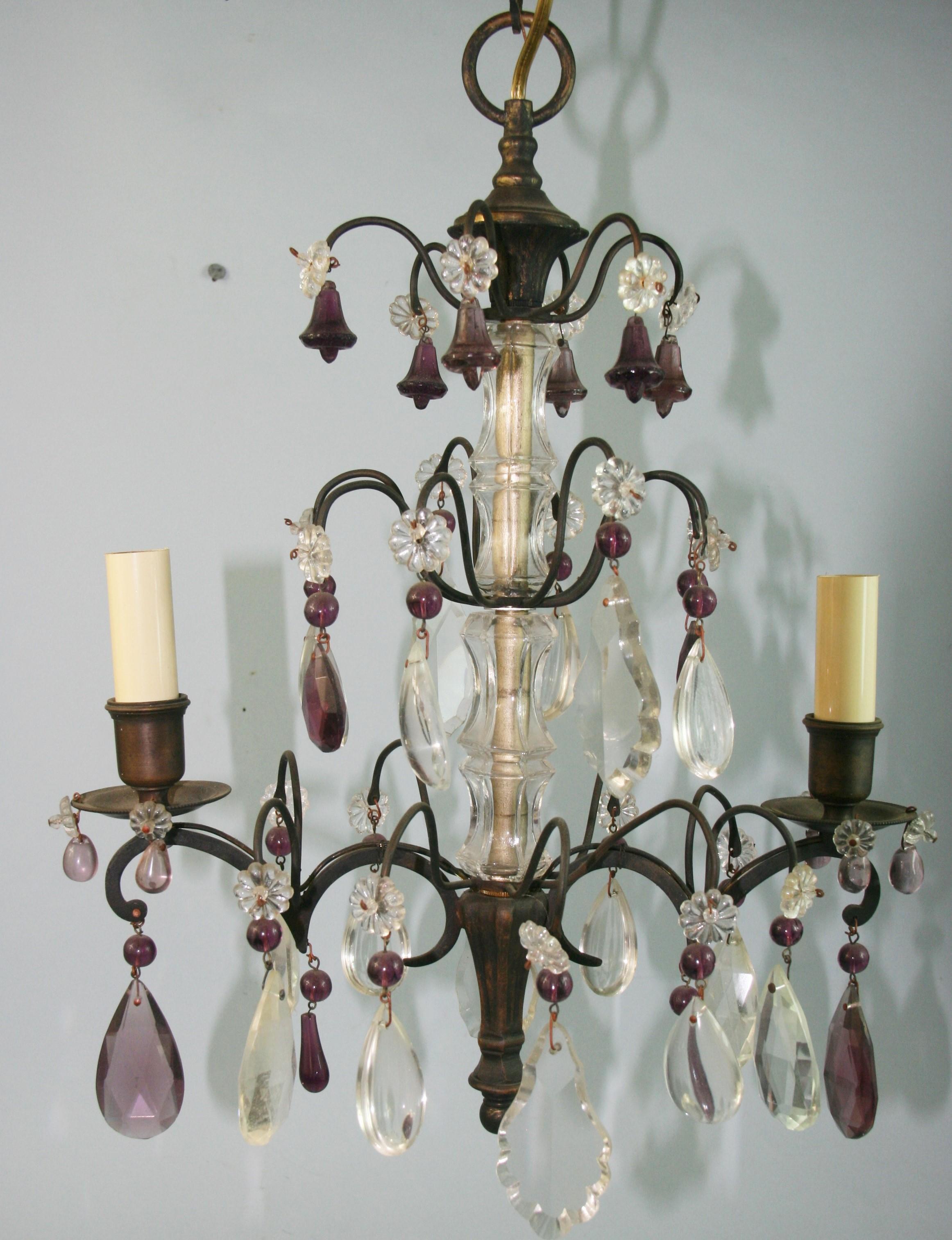 1620  A French two-light chandelier decorated with amethyst bells and clear crystals.
Takes 2 60 watt candelabra based bulbs.
 
 