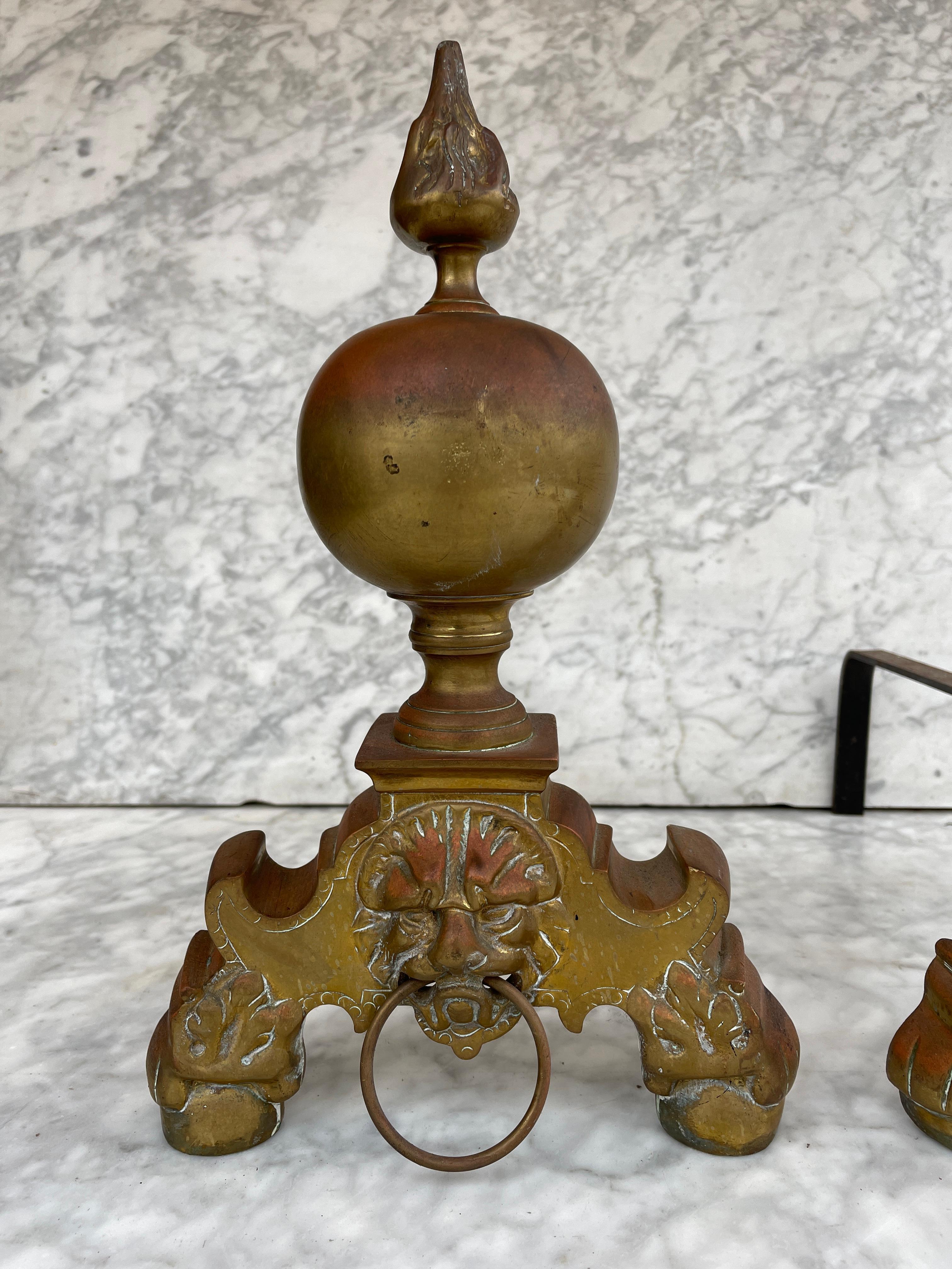 Antique French andirons or firedogs, 19th century cast iron and brass with a lion sculpture op front.
 