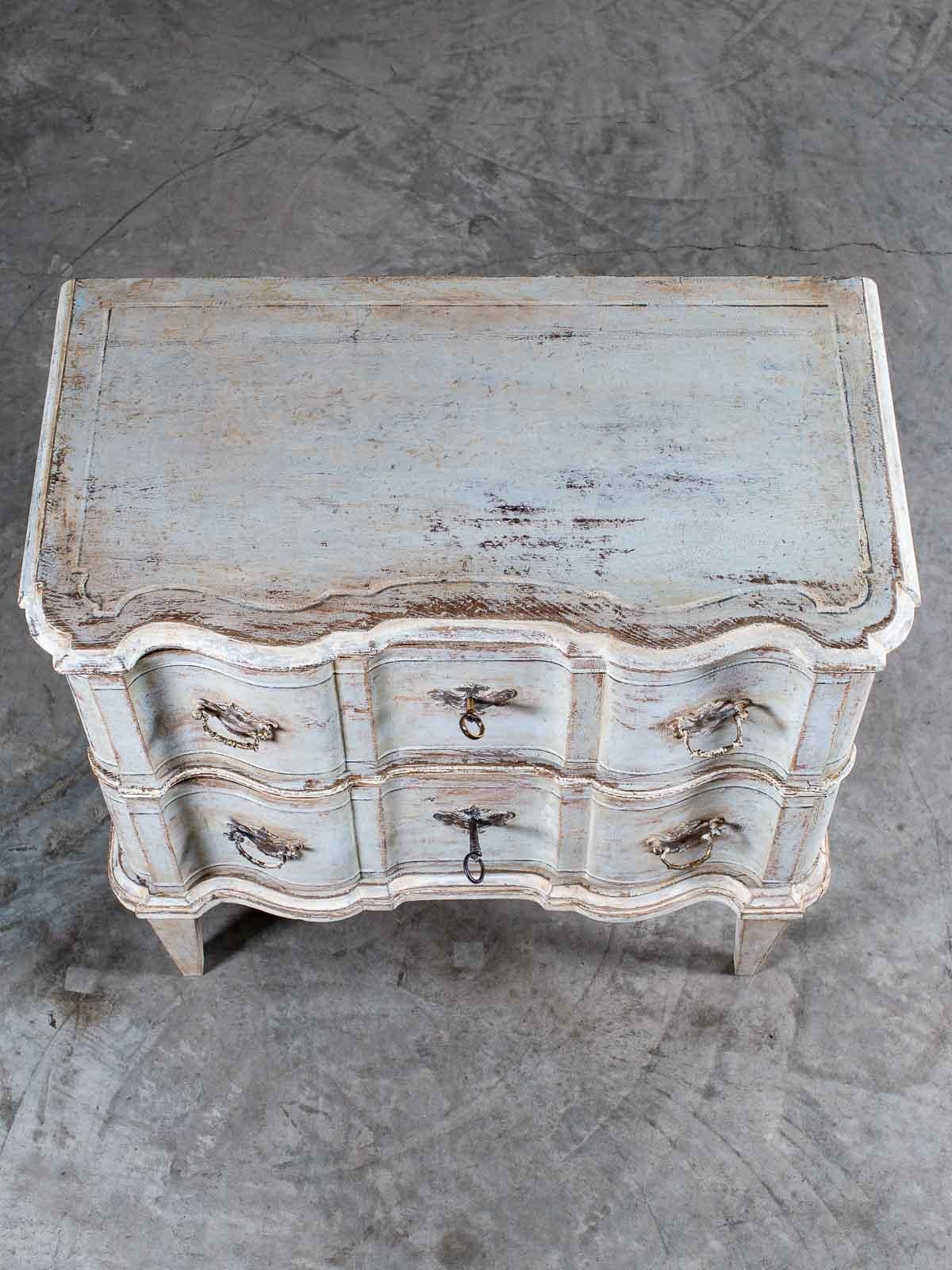 A striking antique French arbalette front painted chest of drawers from France, circa 1770. Please enlarge the photographs to see the details that make this such a fine example of eighteenth century craftsmanship. The entire façade of this chest of