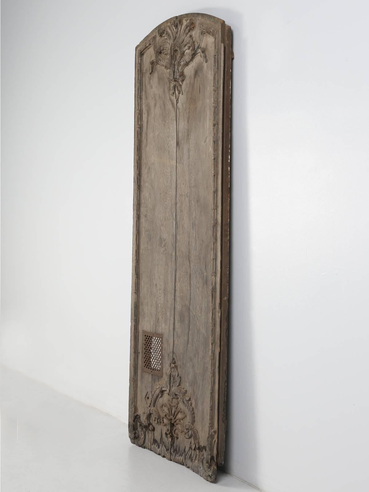 Antique French architectural carved panel or possibly a door from the early 1700s and it appears to be in completely un-restored condition. There is a grille at the bottom, which could have been for a small animal for air or for pies? All that I