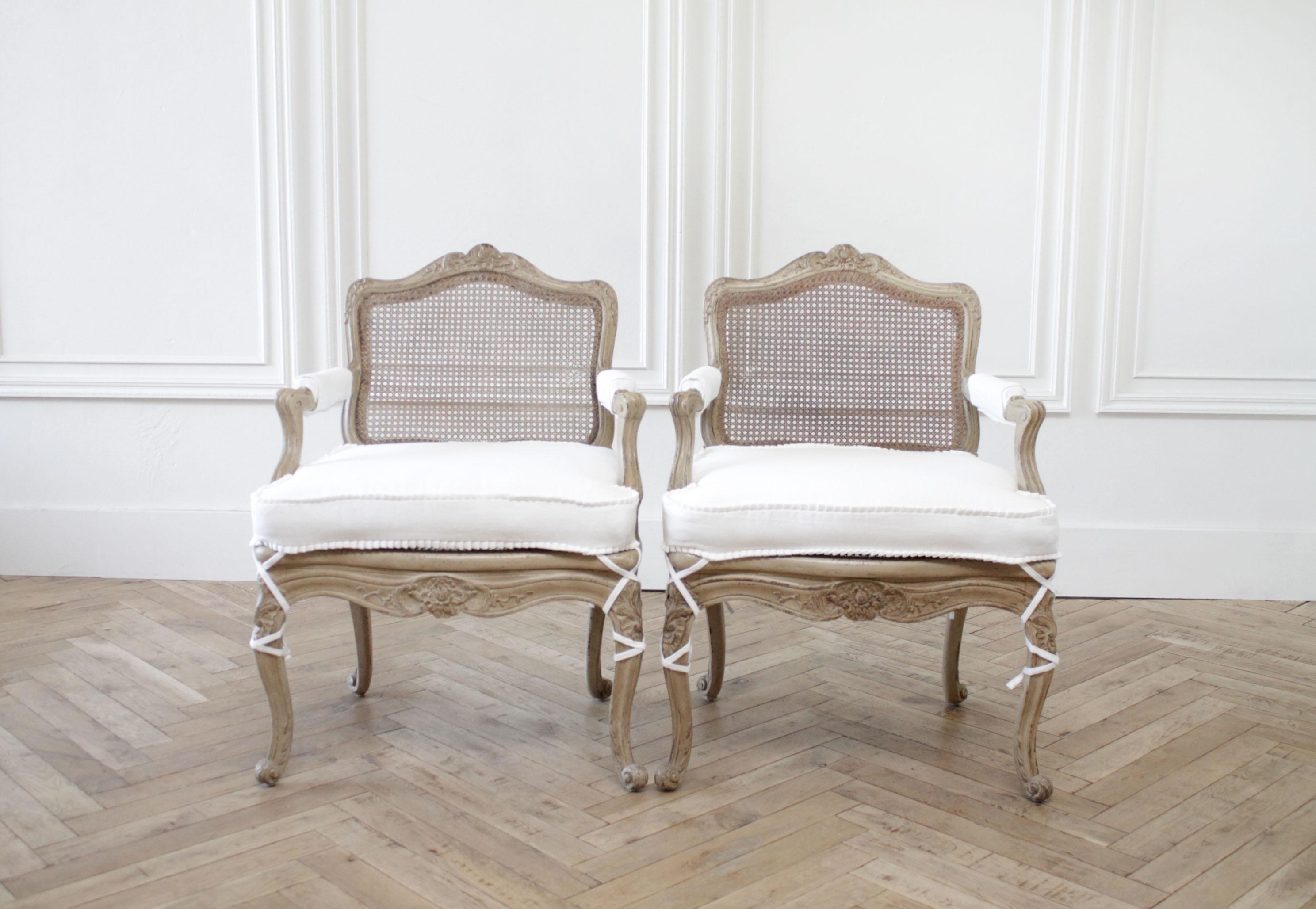 Only 1 left.
Antique French armchairs in original painted finish and white linen
these chairs are painted in a putty grey tone, it is the perfect natural linen taupe color, with subtle distressing that is natural from original wear. The cane is