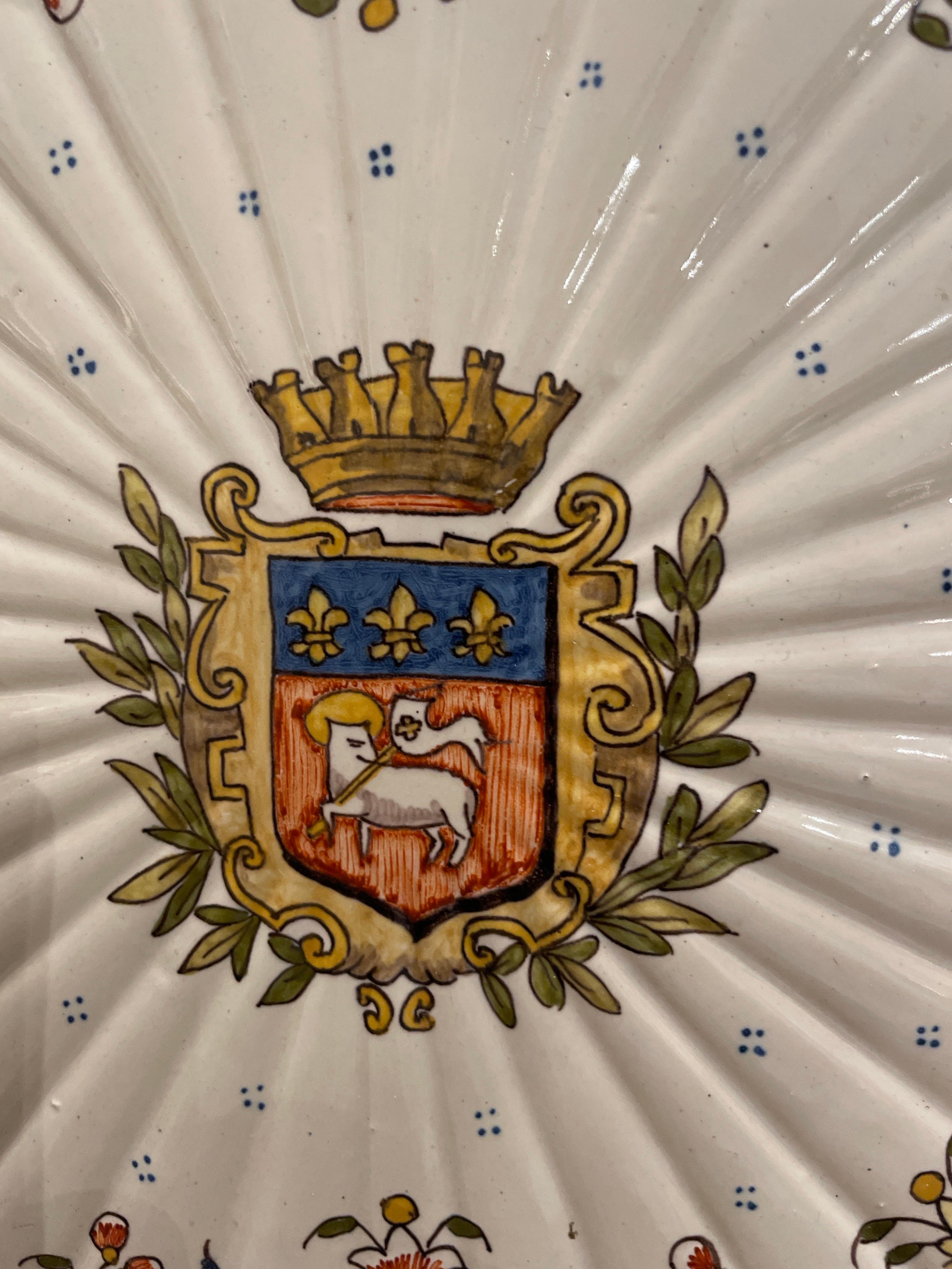 Antique French Armorial Charger from Rouen. Blue, green, yellow and orange on a cream background. Centered with a coat of arms topped with a crown & surrounded with a laurel wreath.