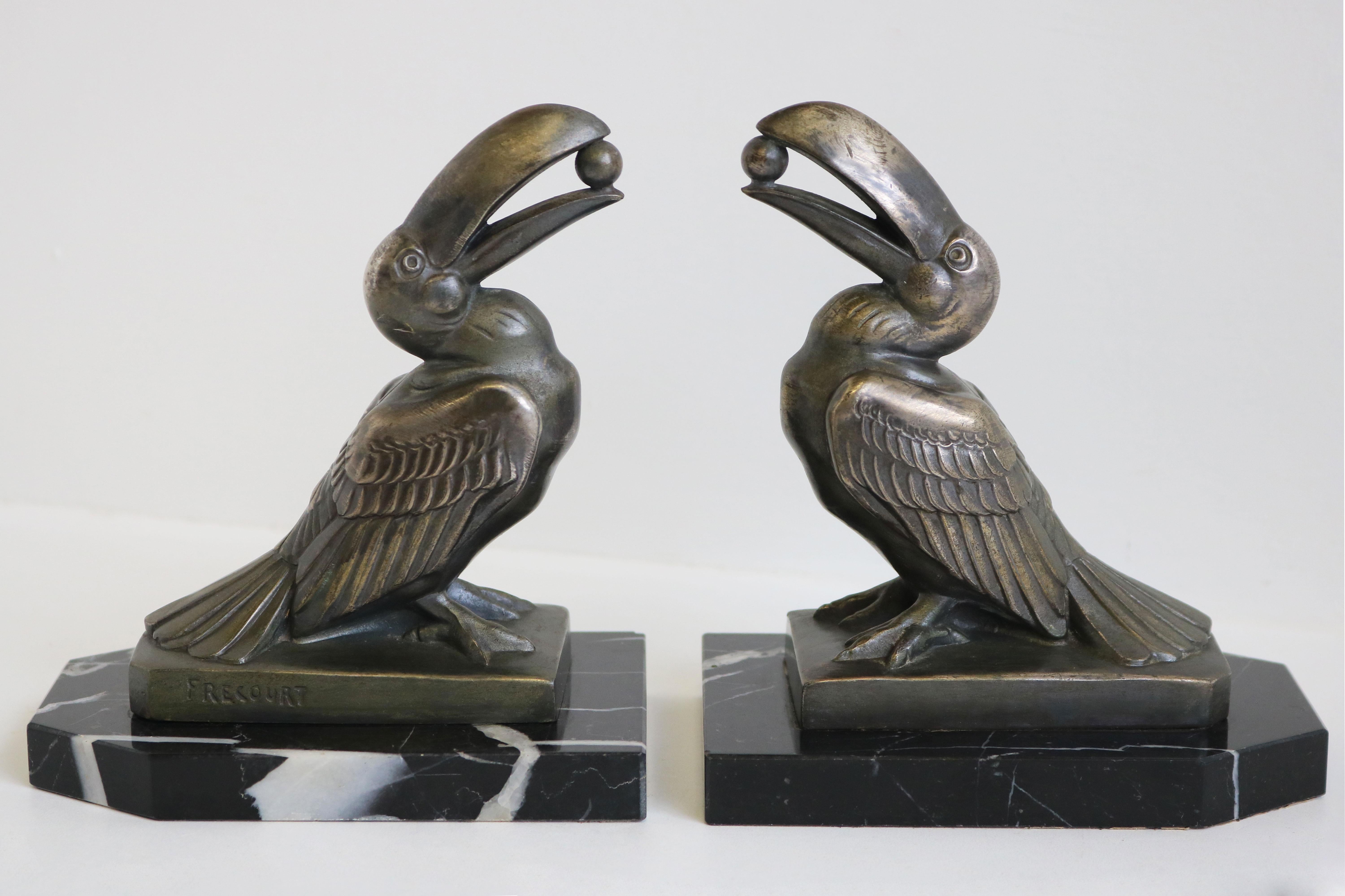 Marvelous pair of French Art Deco bookends by Maurice Frecourt 1925. Very desired Toucans holding Sphere model. 
Made out of Nero Marquina black marble & spelter with amazing patina. 
Maurice Frecourt is famous for his Art Deco style animal