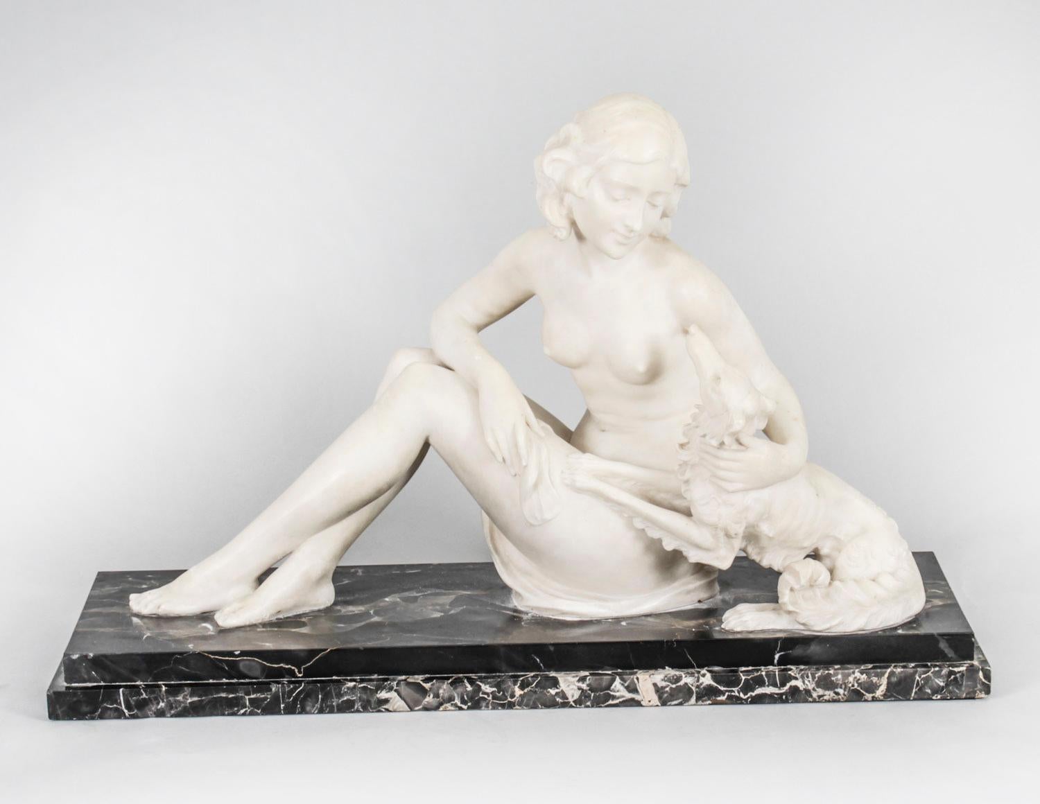 This is beautiful antique French Art Deco marble sculpture of a beautiful maiden with her borzoi dog, indistinctly signed, Circa 1920 in date.
The reclining nude body has been sensitively modelled in carrara marble with her head tilted to the right,