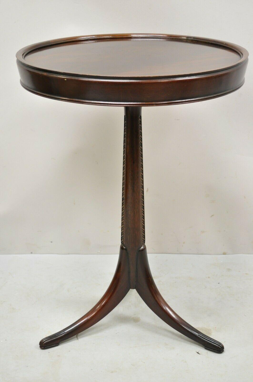 Antique French Art Deco carved tripod base mahogany side table. Item features carved tripod base, crotch mahogany top, sleek tapered shaft, beautiful wood grain, clean modernist lines, great style and form. Circa Early to Mid 20th Century.