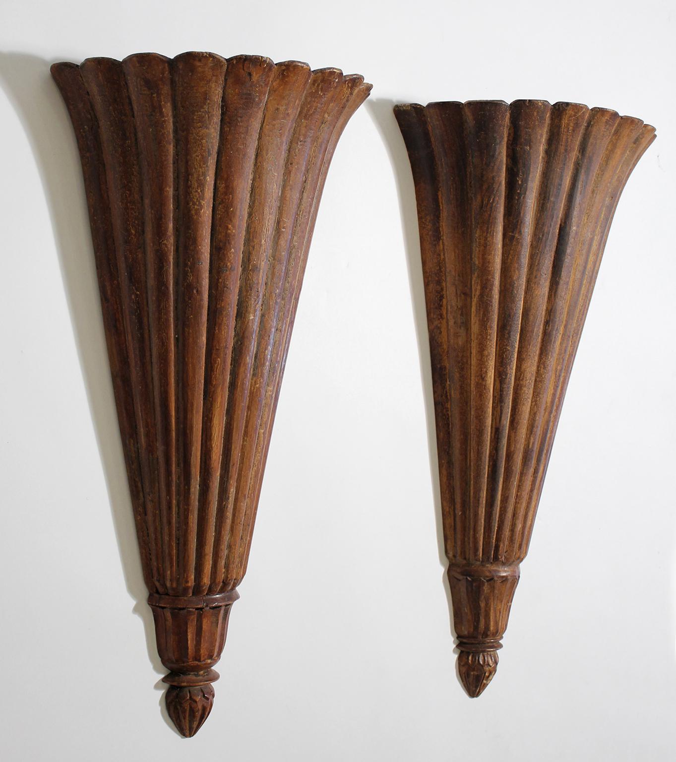 Wonderful pair of antique French Art Deco wall mount carved wood shelves. In the shape of popular sconces from this era. Great form and design. Shelves sit lower down to give a coved effect. Would look great with plants in them. In very nice