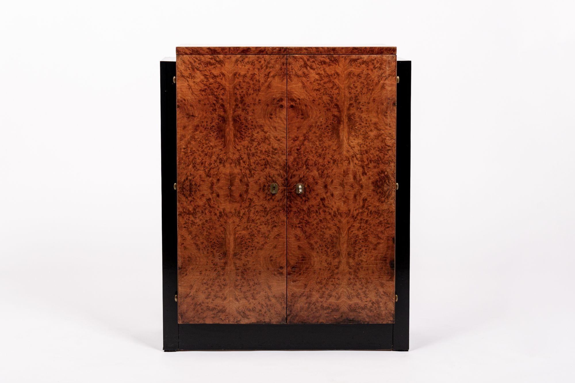 This beautiful antique French Art Deco burl wood and black lacquer cabinet was made in France circa 1930. This small cabinet has a distinctive rectangular form and moderne design and is carefully handcrafted from match-booked Carpathian elm burl