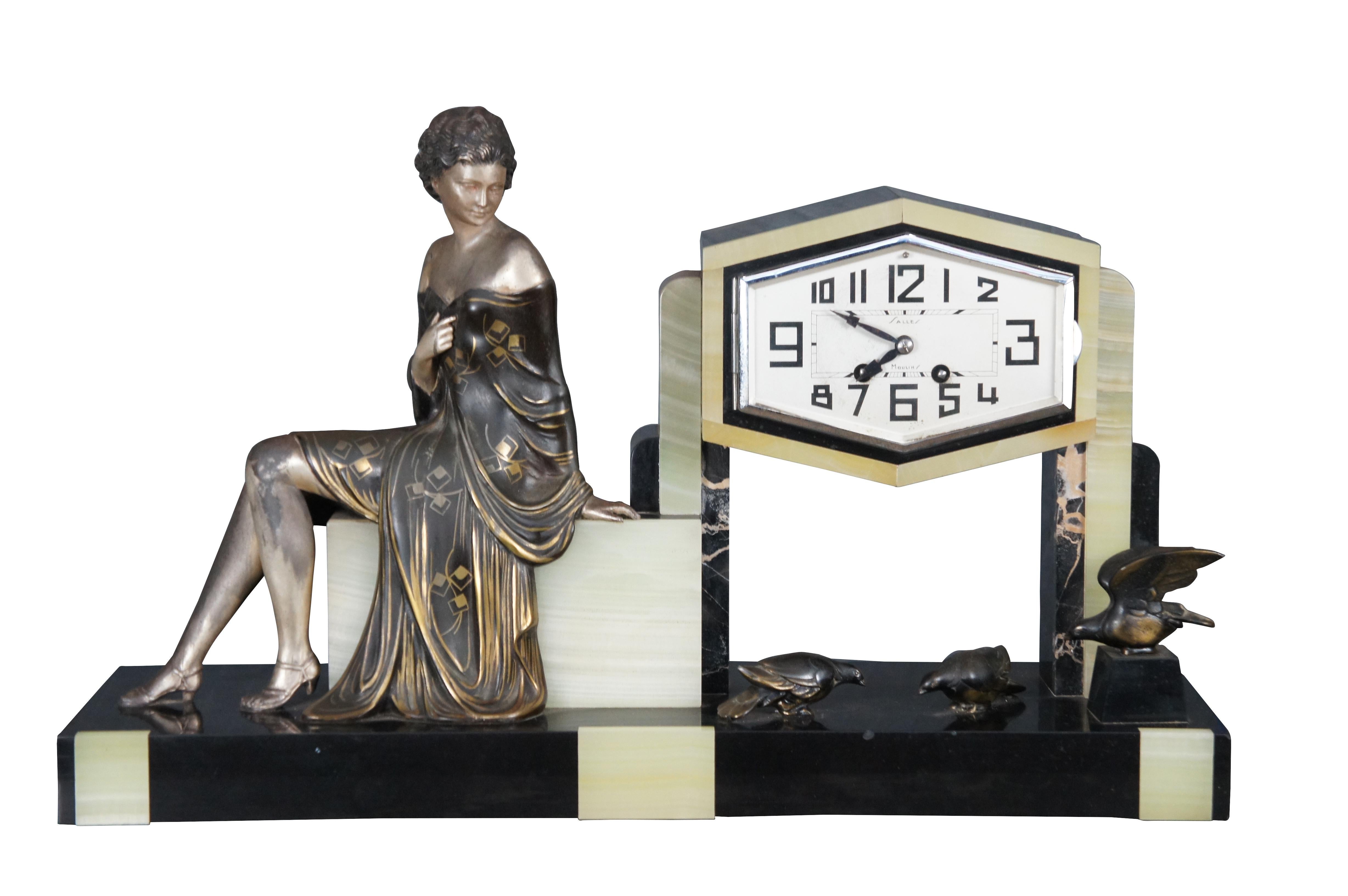 An exceptional and difficult to find Art Deco Garniture Clock Set depicting a young lady looking down at birds below. Set between lovely Garnitures of cups or vases with tapered shapes on matching bases. A beautifully detailed piece of the finest