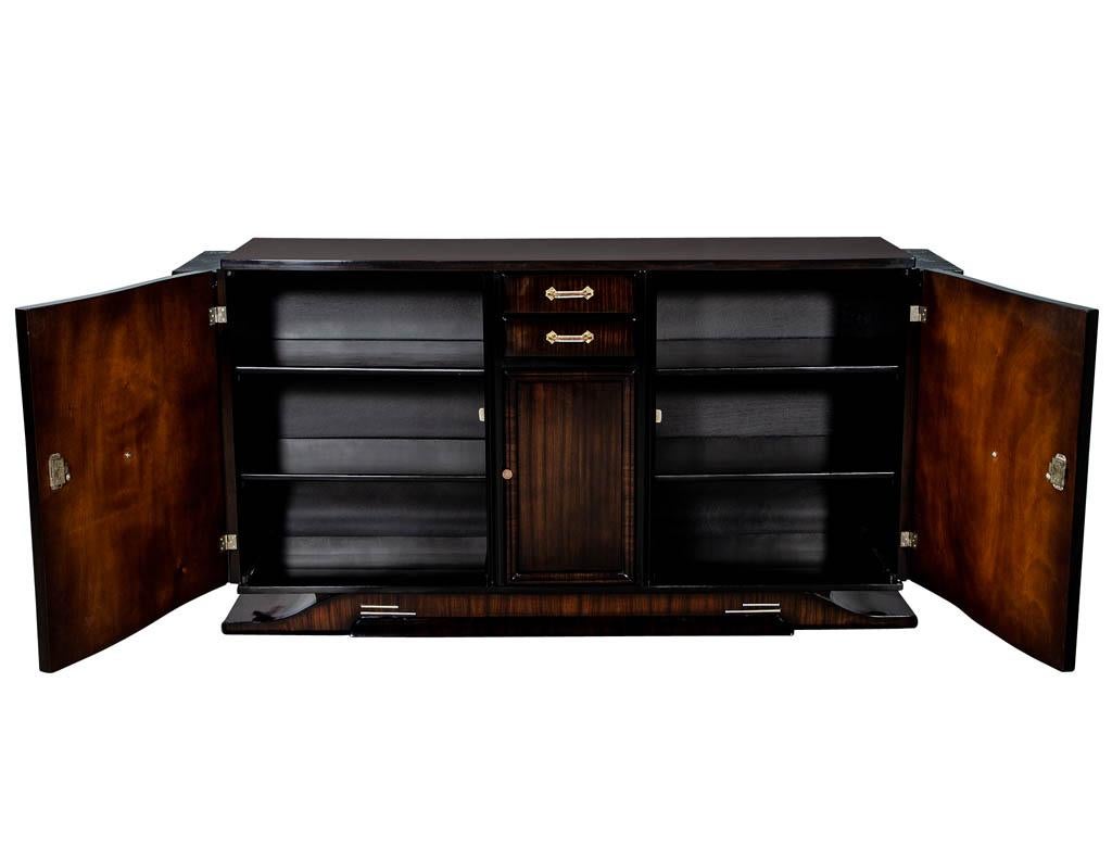 Spectacular original Art Deco buffet professionally finished and hand polished to perfection. With the original handmade tri-metal handles and marble top ends, this exceptional piece will stand out beautifully in any setting.
