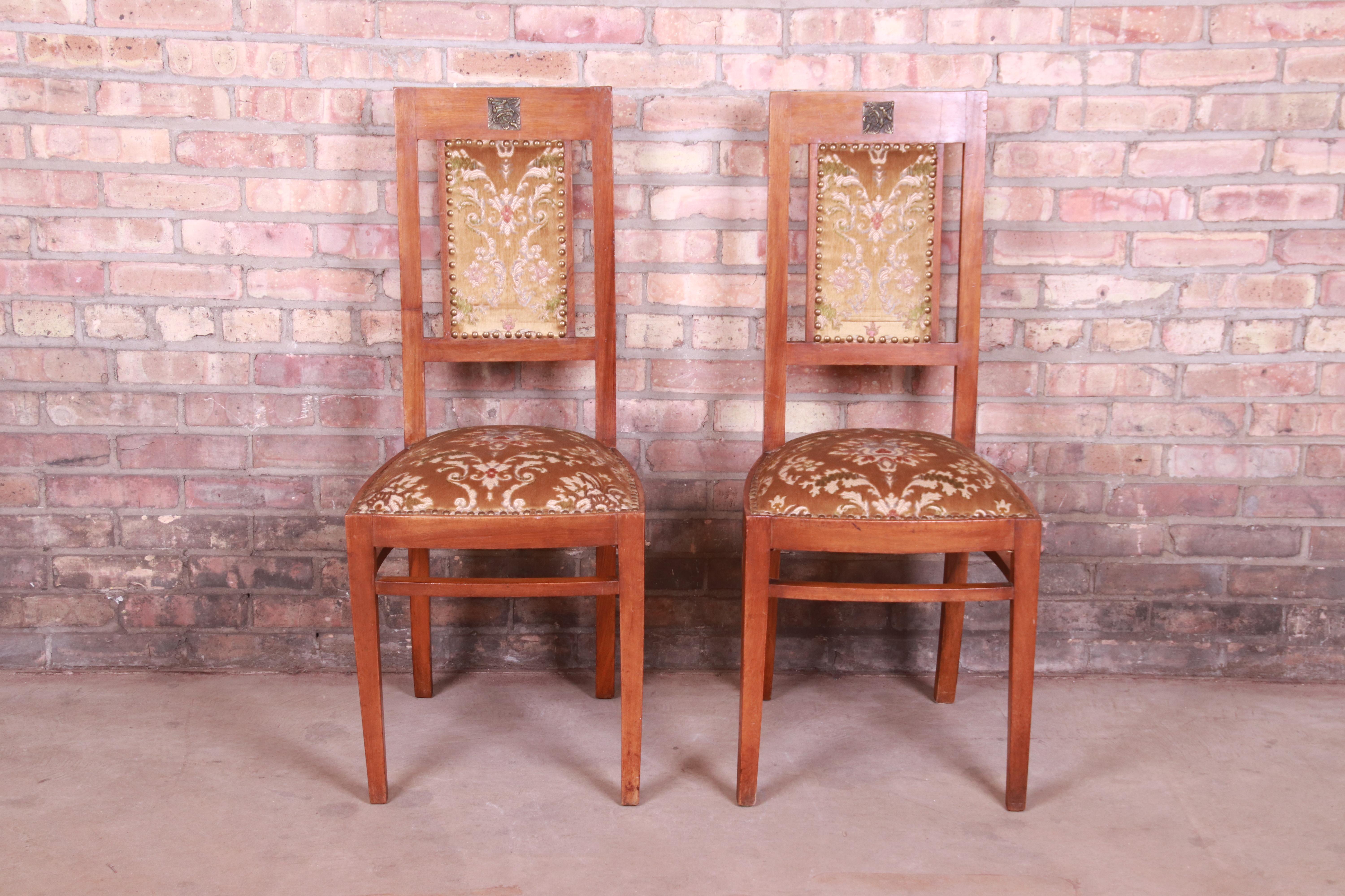 A gorgeous pair of Art Deco side chairs

Early 20th century

Solid wood frames, with brass insets and cut velvet upholstery.

Measures: 16.5