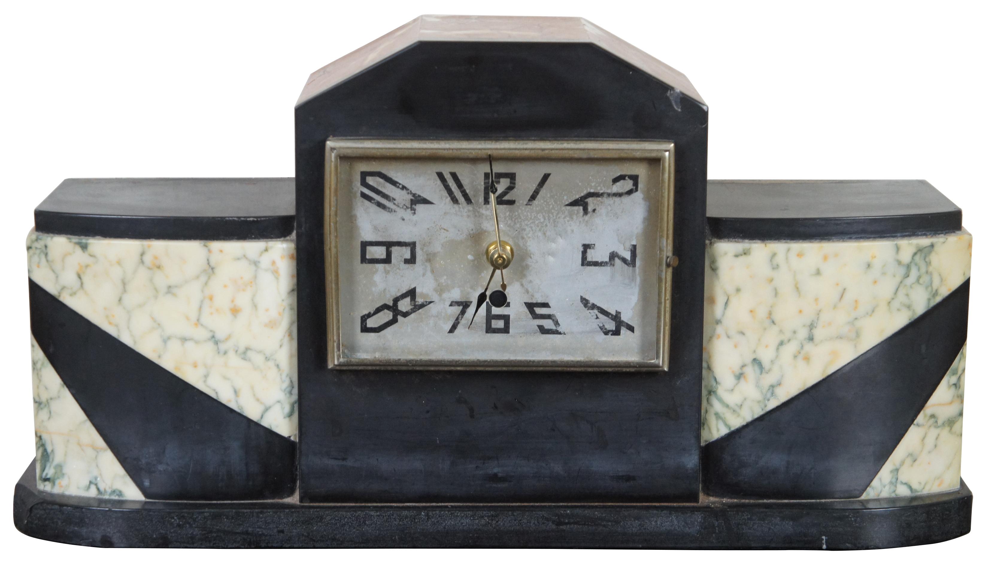 Three piece, black, white and salmon marble mantelpiece set, including an art deco clock and bookends.

Measures: Bookends - 6” x 3.5” x 7” / Clock - 18” x 4.75” x 9.5” (Width x depth x height).