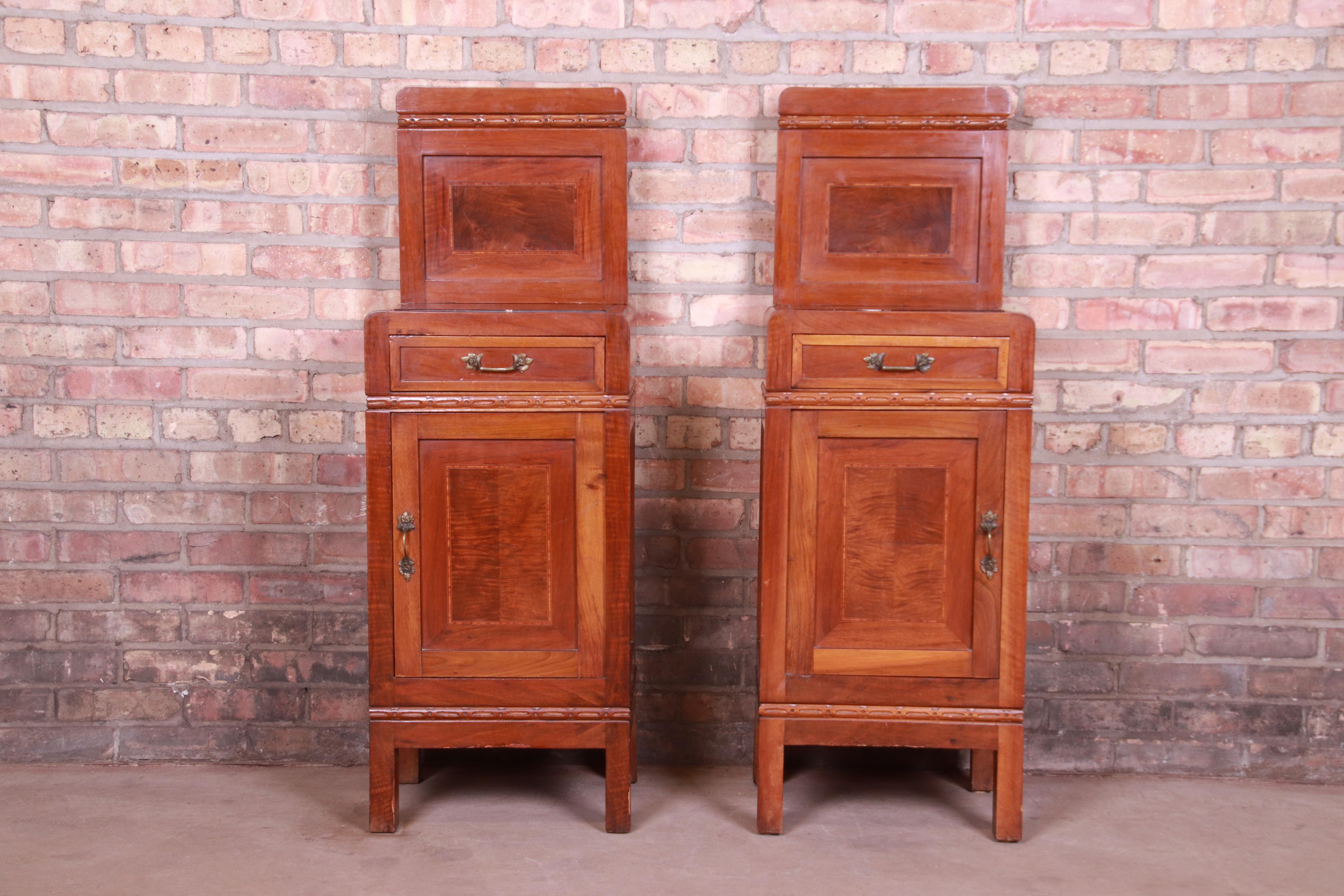 A gorgeous pair of antique French Art Deco nightstands

France, circa 1920s

Mahogany, with satinwood inlay, marble tops, and original brass hardware.

Measures: 15.75