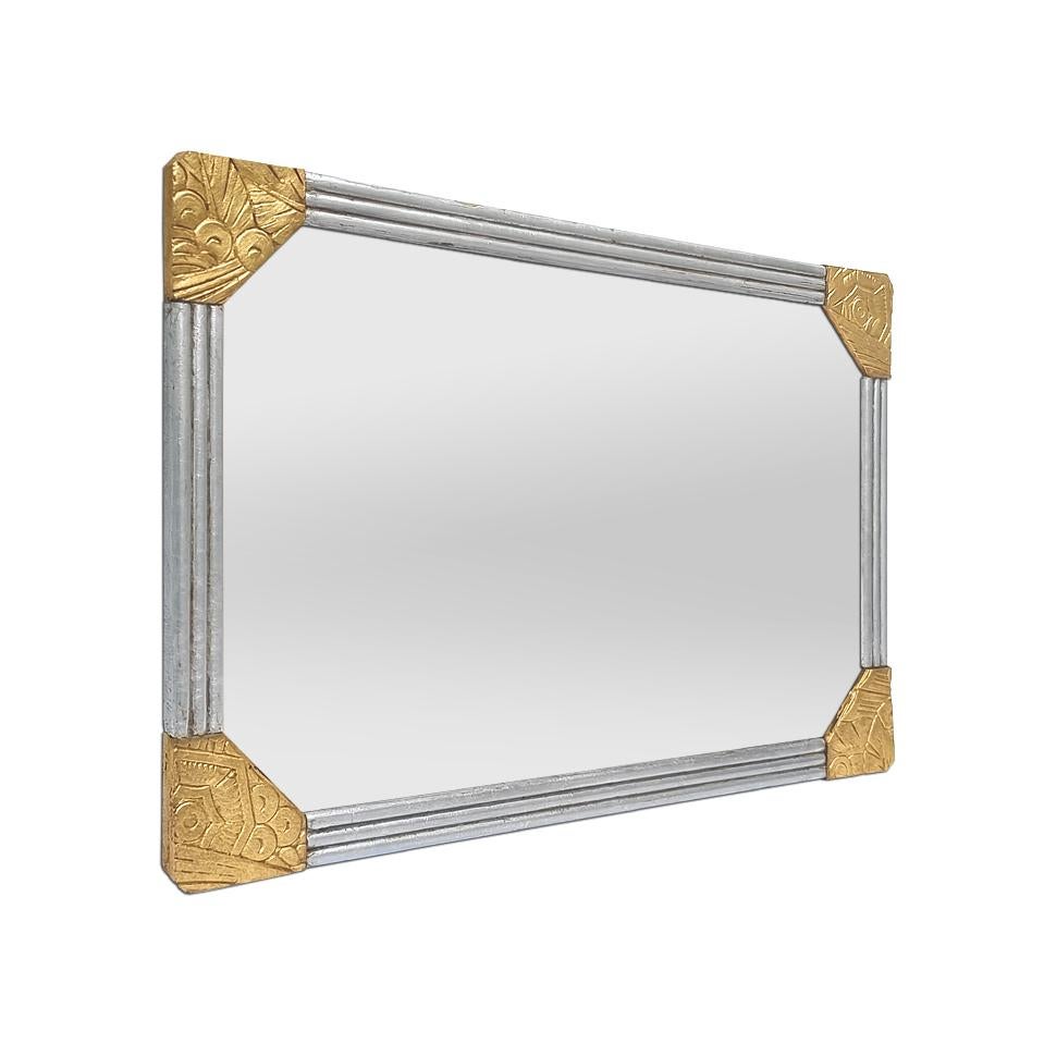 Antique French Art Deco small wall mirror, circa 1930. Carved wood frame with Art Deco-style gilded decoration in the 4 corners and grooved silver frame. Antique frame re-gilding with leaf. Frame width: 2.5 cm / 0.98 in. Modern glass mirror. Wood