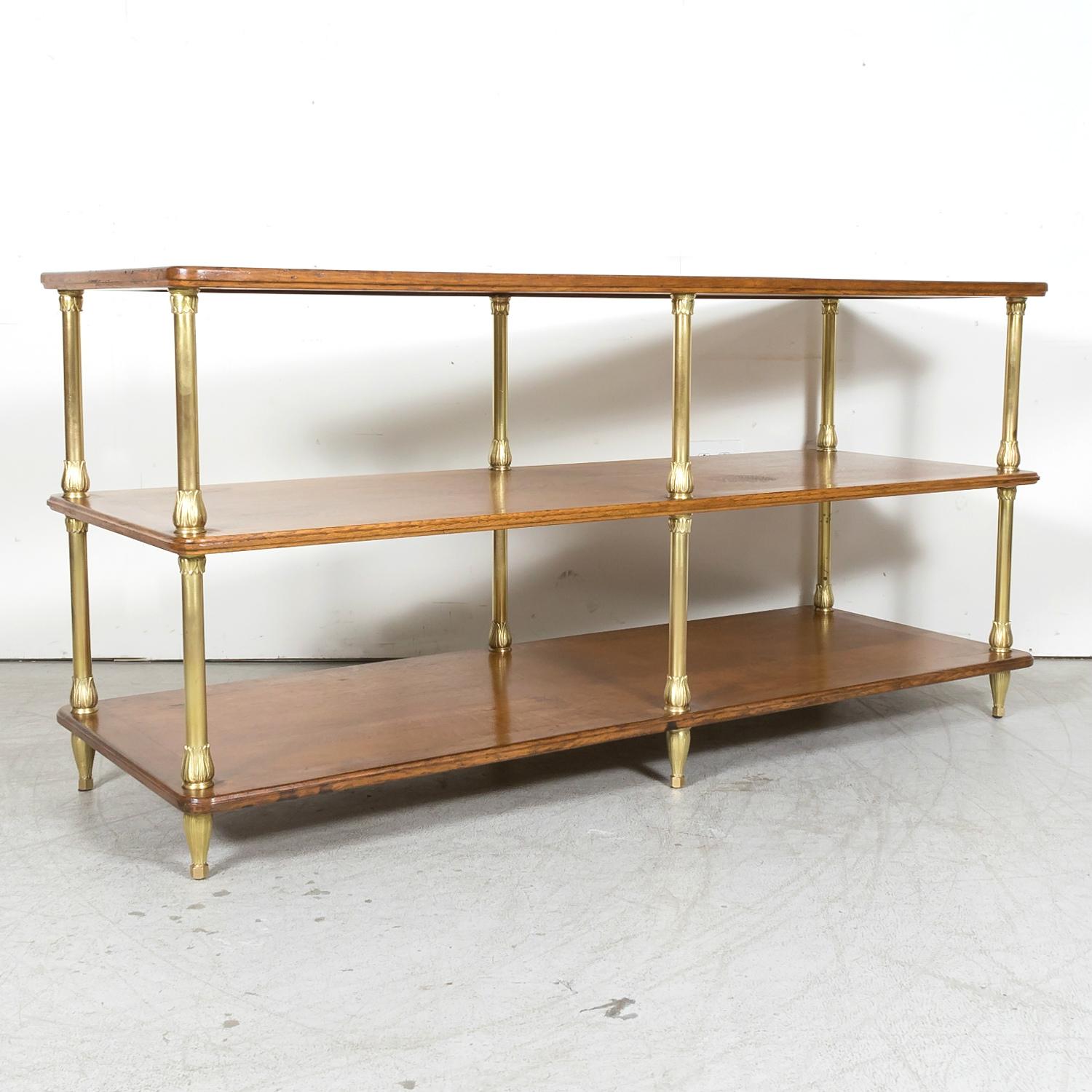 A rare early 20th century French Art Deco display table handcrafted of solid oak and brass in the Île de France region, circa 1930s. Found in a ladies clothing atelier in the heart of the Left Bank in the Saint Germain des Pres neighborhood of